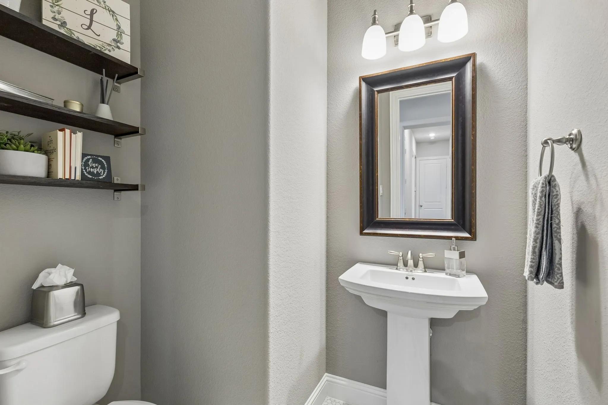 First-Floor Half Bath With Designer Tile And Pedestal Sink