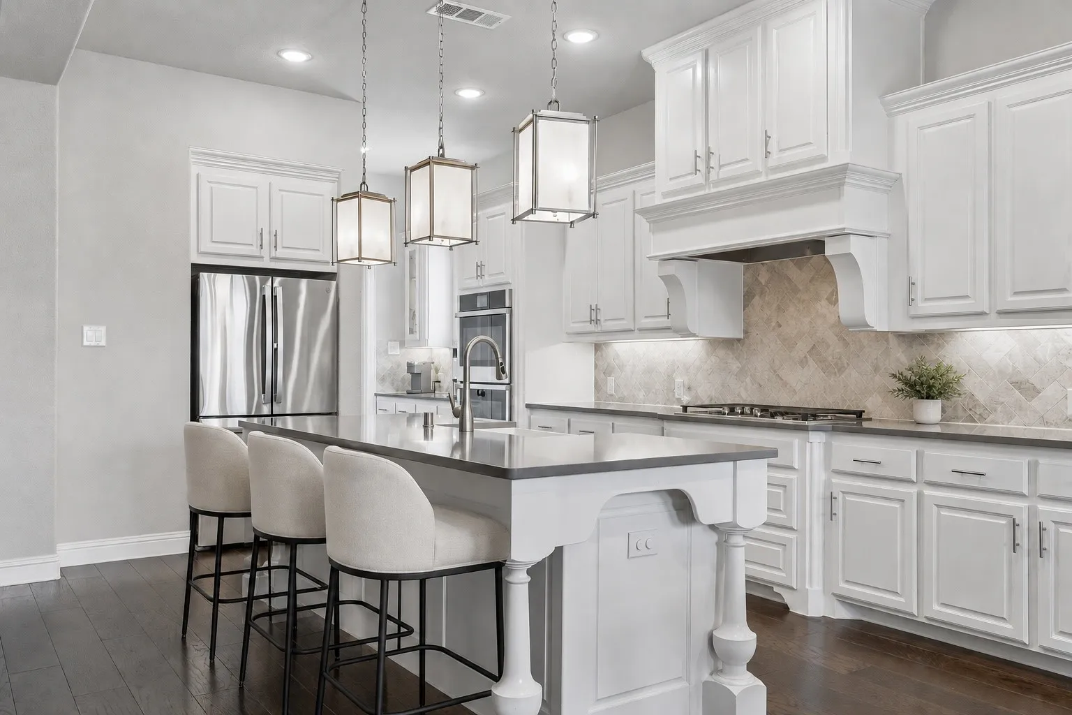 Chef’s Kitchen Featuring Apron Sink, Wood Vent Hood, And Oversized Island with Turned Legs