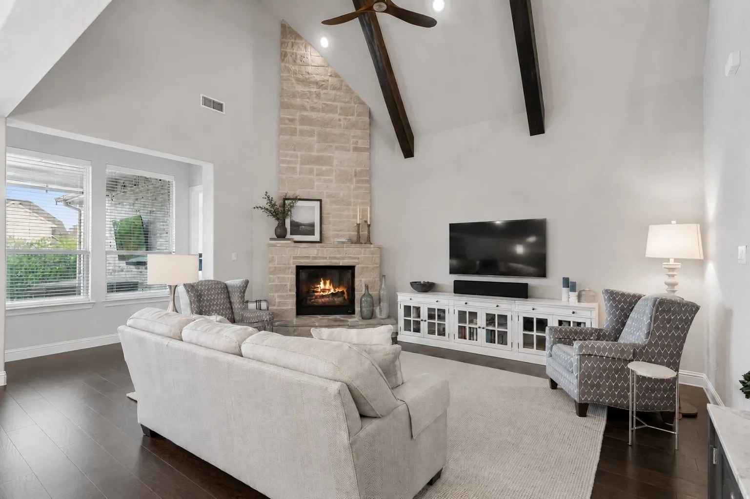 Main Living Anchored By Floor-To-Ceiling Stone Fireplace And Beamed Vaulted Ceiling