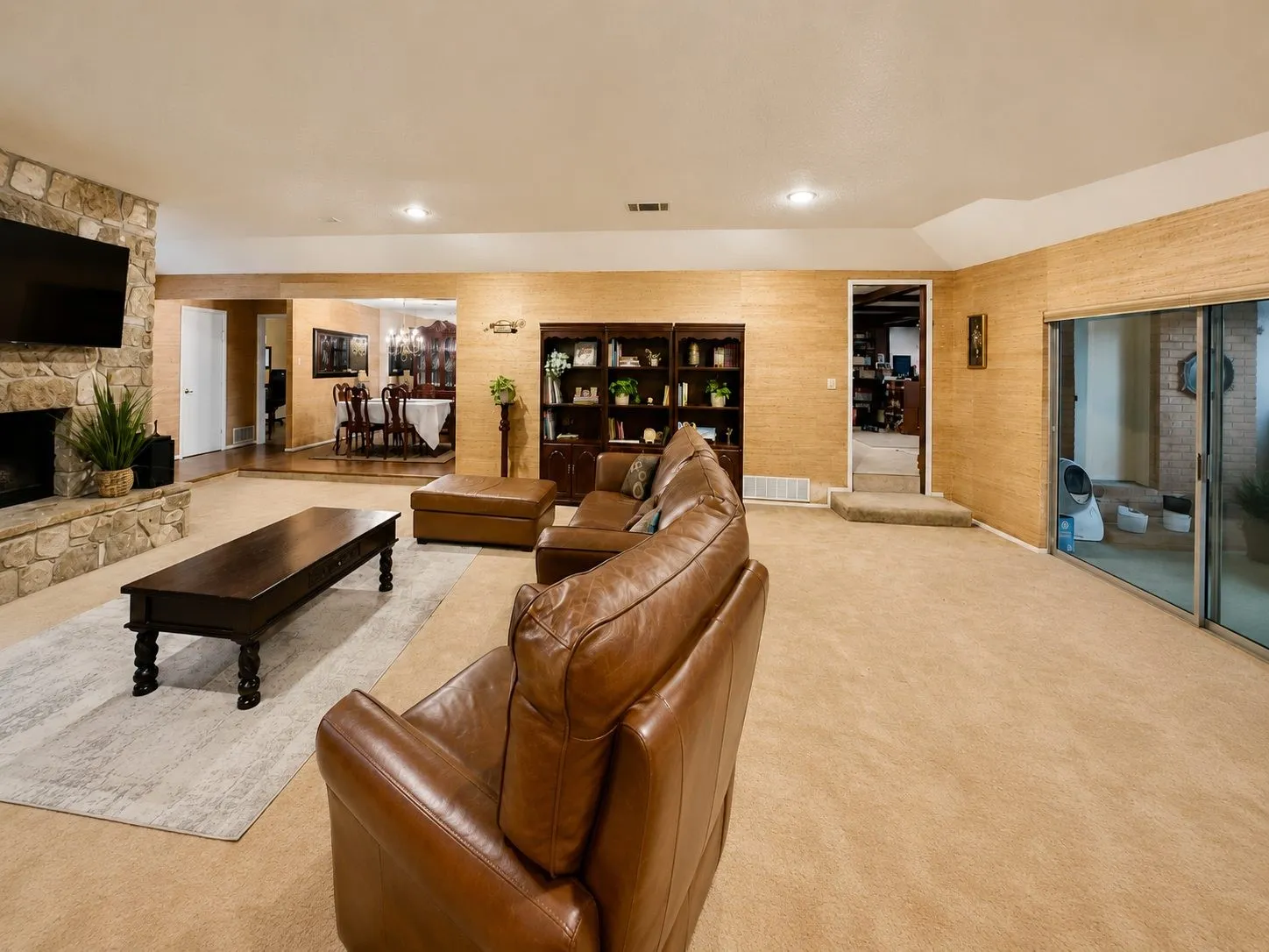Open Lliving and Dining with Stone Fireplace