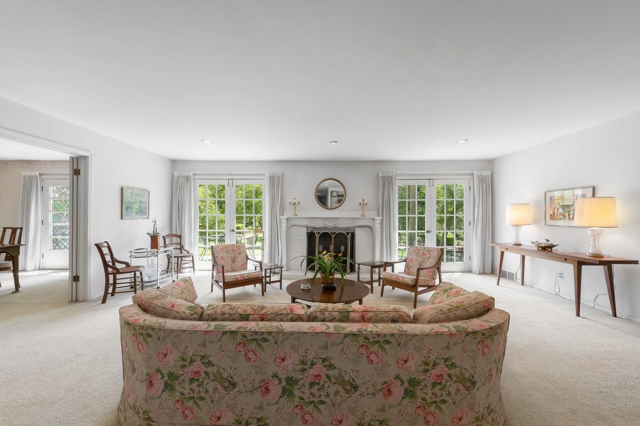 Living Room with two sets of French Doors for views of back yard.  Wood Burning Fireplace.