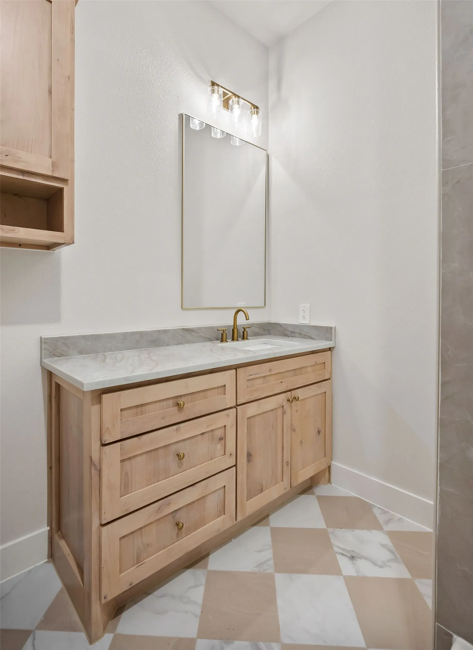 Wood-finish vanity with an integrated sink and light-colored countertop