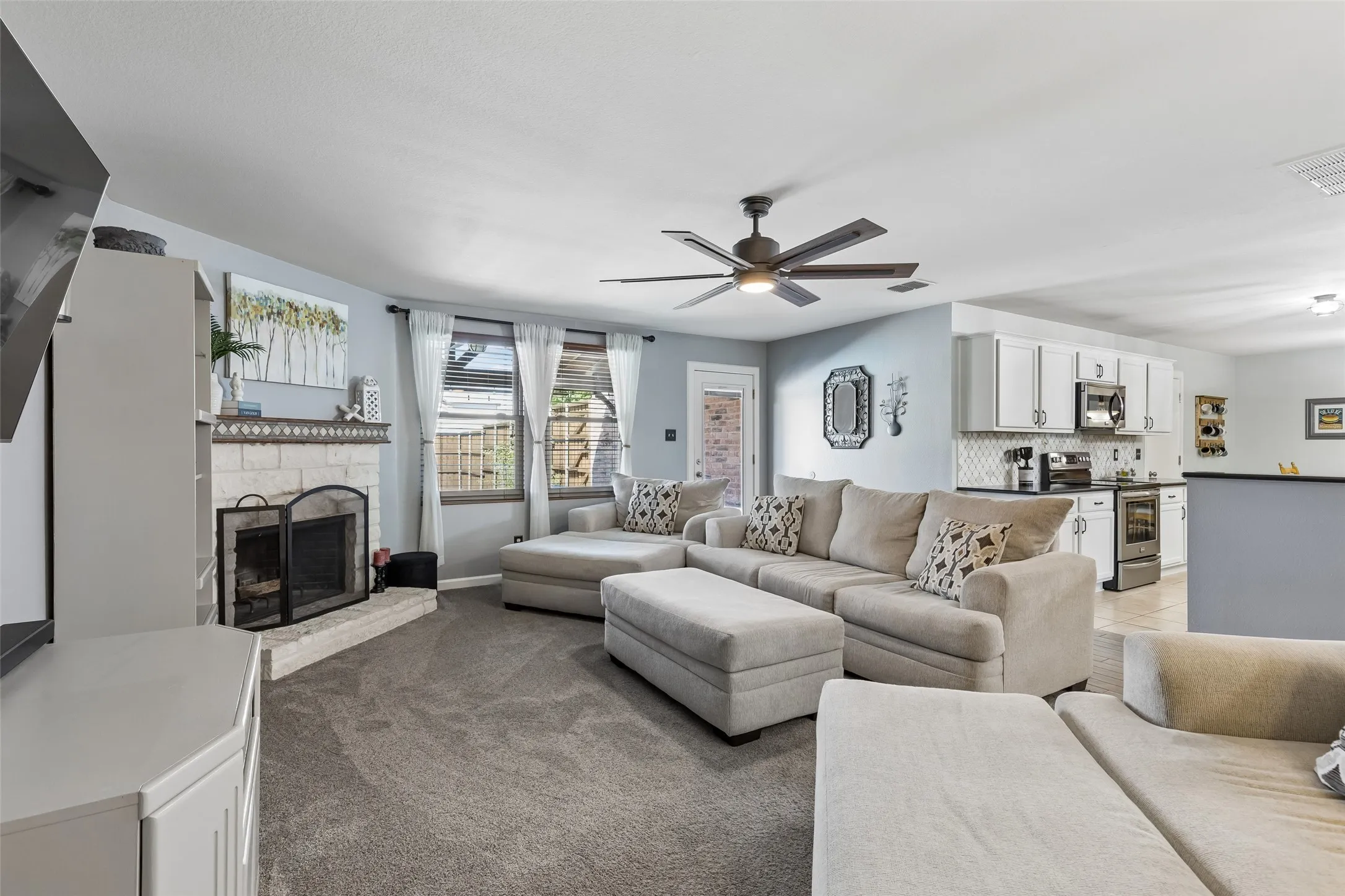 Indoor-Outdoor Living at the Heart of the Home – Large windows and direct backyard access connect the family room to the covered patio and pool area, while the nearby kitchen keeps everyday meals, entertaining, and outdoor time conveniently connected.