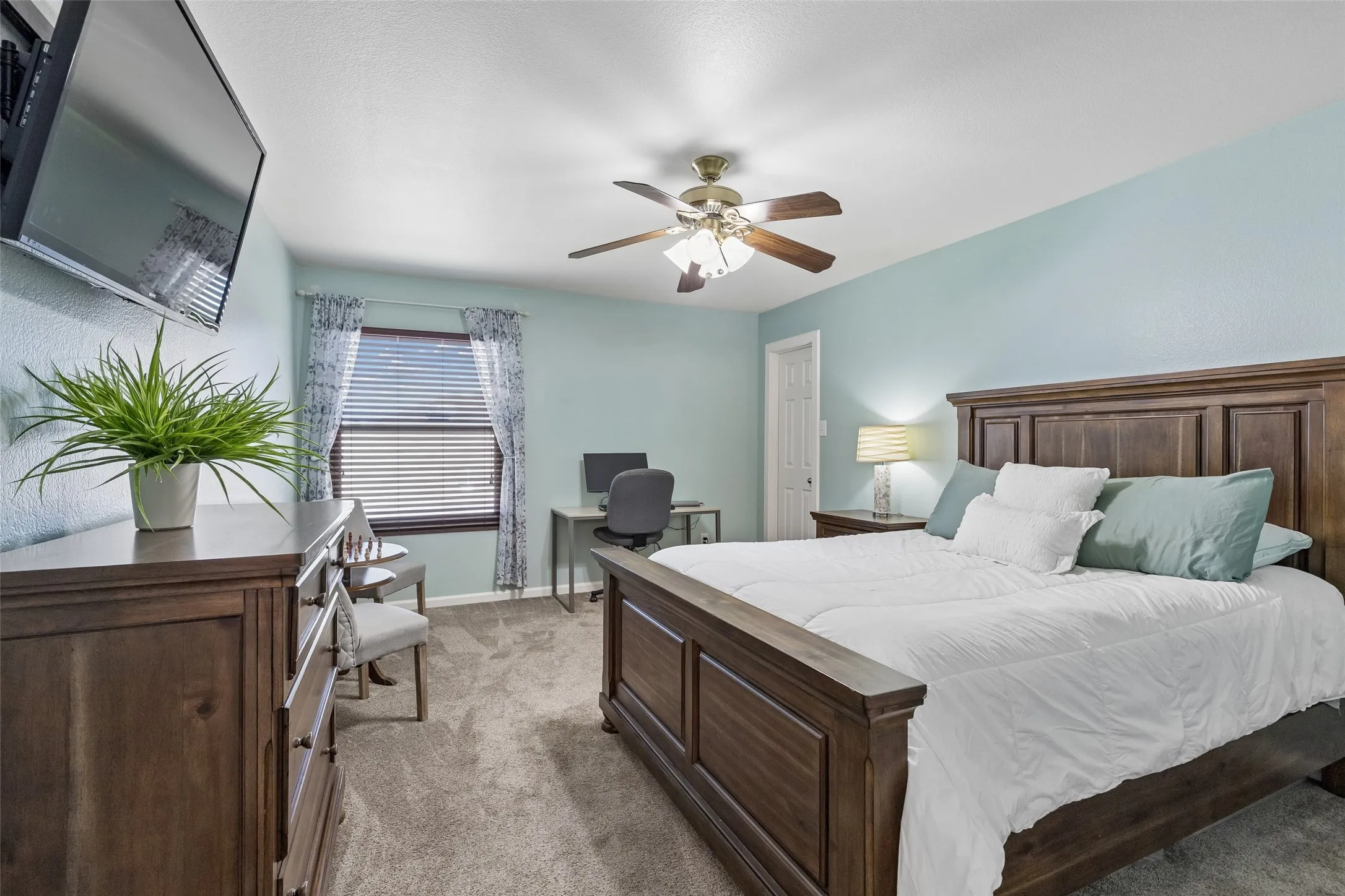 Secondary Bedrooms That Don’t Feel Secondary – This generously proportioned bedroom offers plenty of room beyond the sleeping area, along with a walk-in closet, ceiling fan, and natural light.