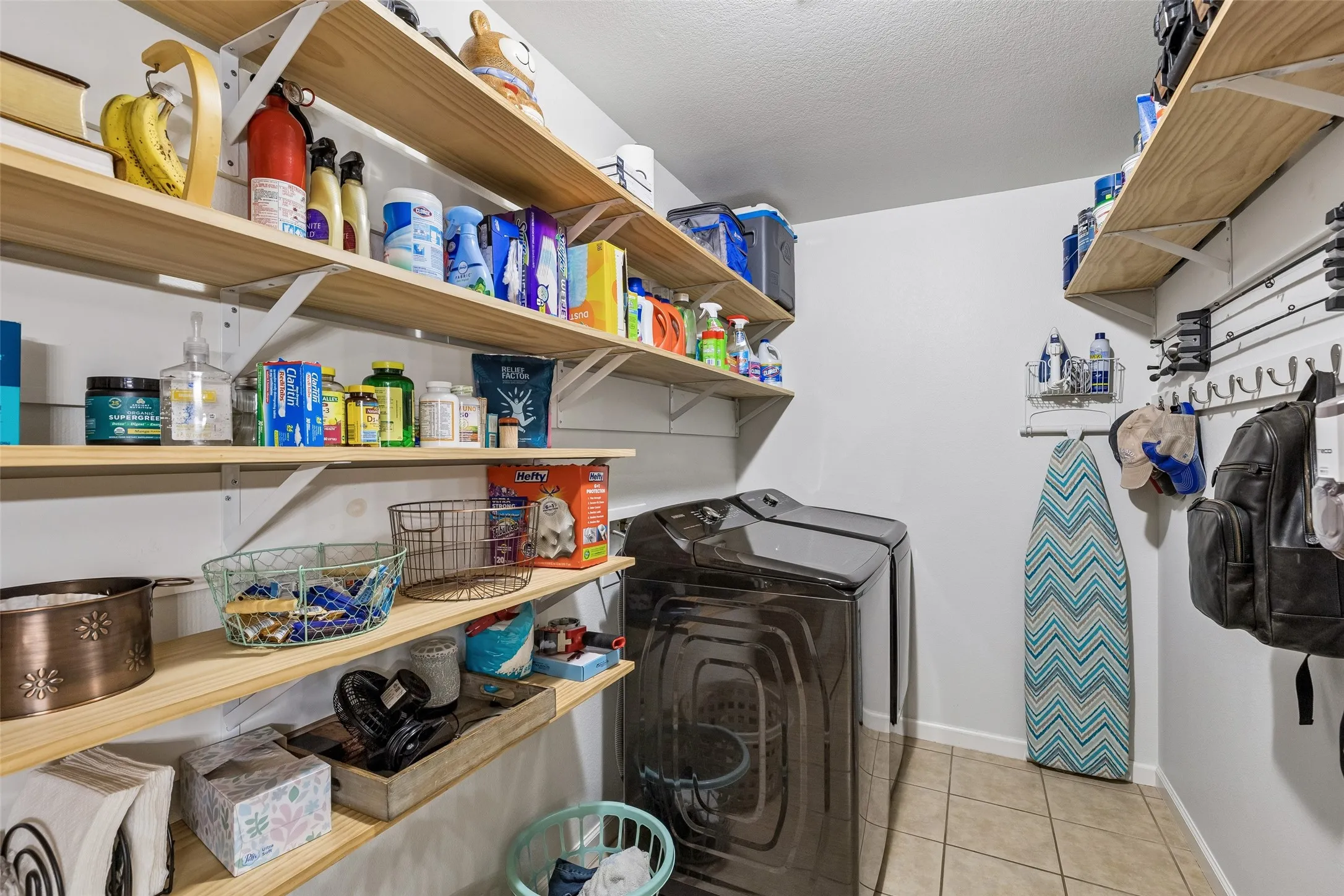 A Pantry That Goes Beyond the Expected – This oversized walk-in pantry and laundry room offers extensive open shelving and valuable storage space for groceries, household supplies, small appliances, and everyday essentials.