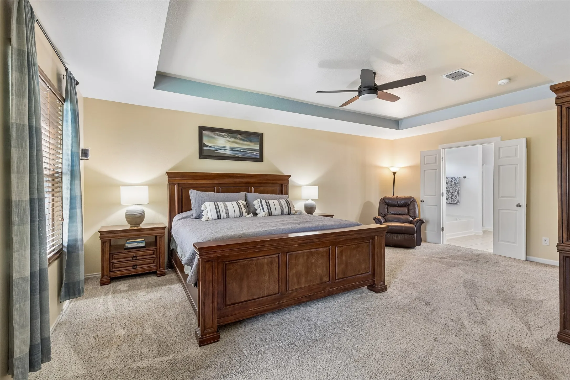 A Primary Suite with Room to Unwind – The approximately 18-by-25-foot primary bedroom offers exceptional space, a tray ceiling, multiple windows, and a direct connection to the private bath.