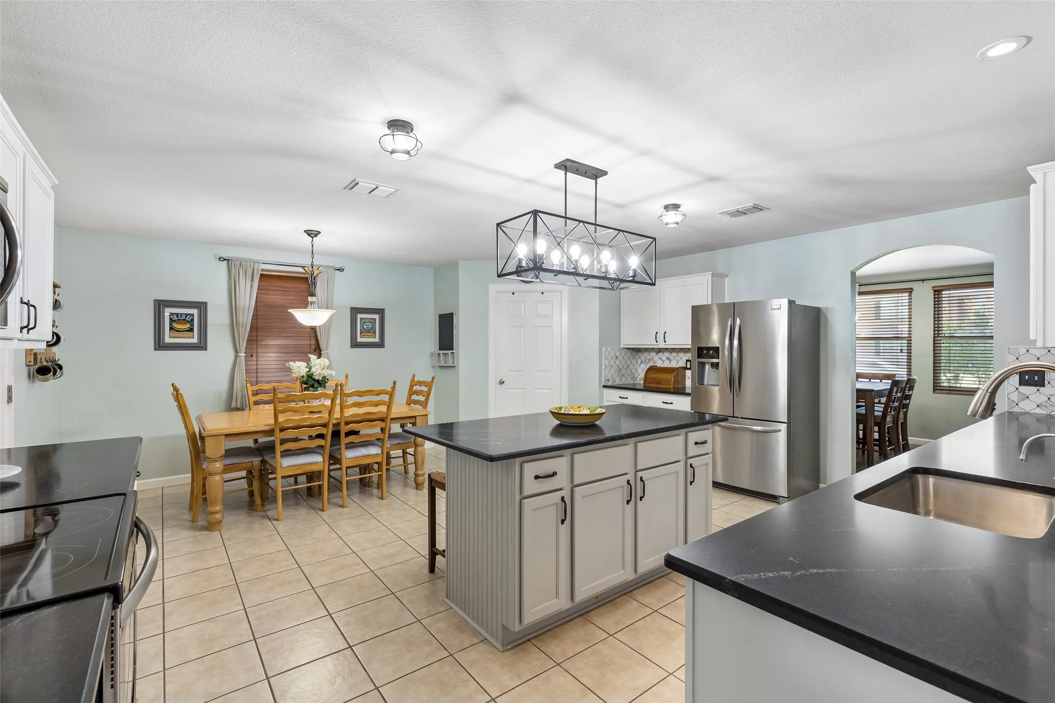 A Kitchen with Serious Workspace – The spacious kitchen delivers an abundance of cabinetry and countertop space, a large center island, updated fixtures, and an adjoining breakfast area designed for easy everyday living.