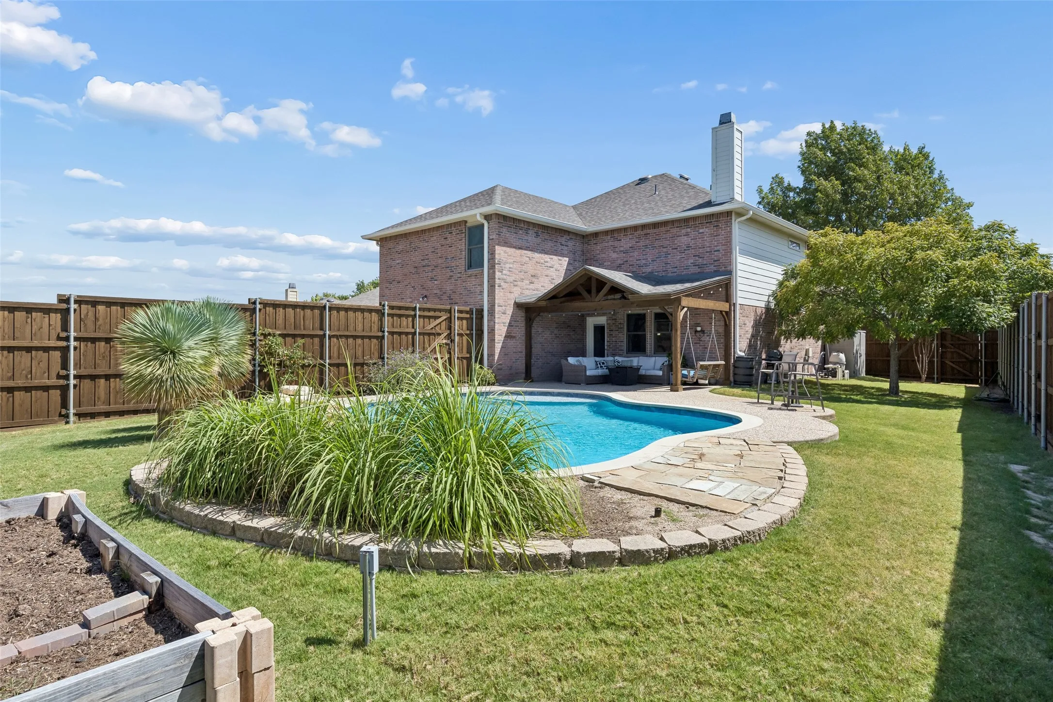 More Backyard Than You Expect with a Pool – Even with the swimming pool and patio, this backyard retains meaningful green space for outdoor activities, gardening, or simply enjoying a more open setting.