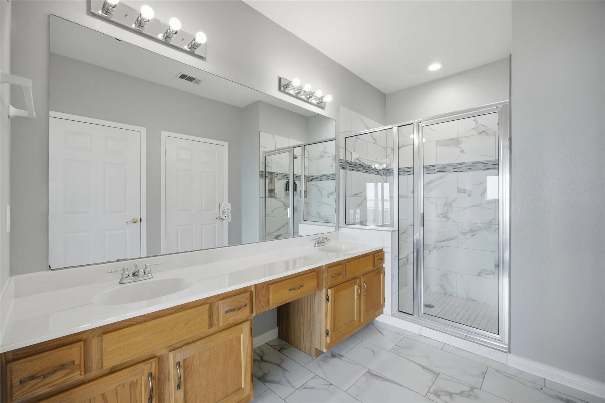 Master bath includes his and her vanities with make up area.