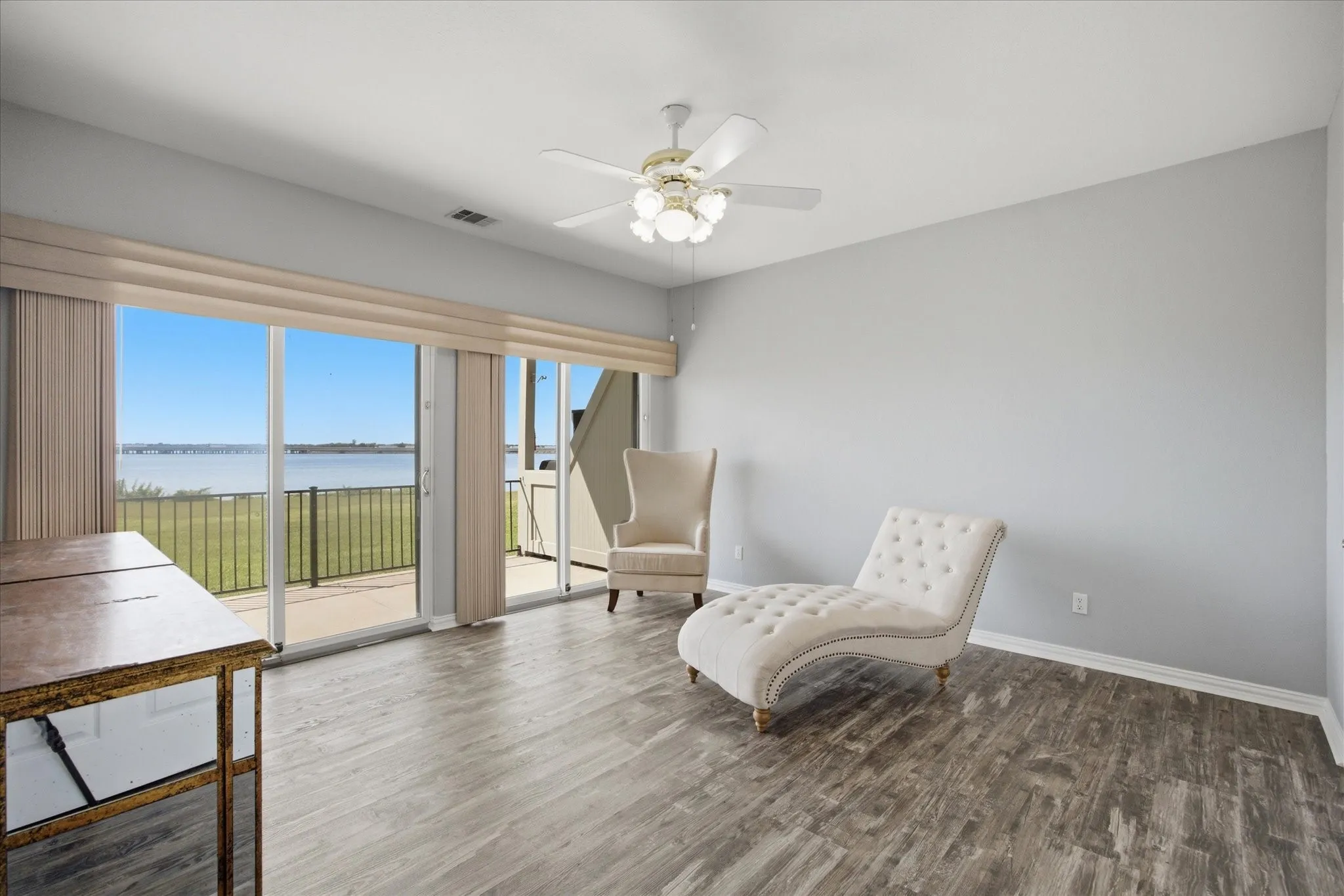 Spacious master bedroom opens onto private patio overlooking the lake