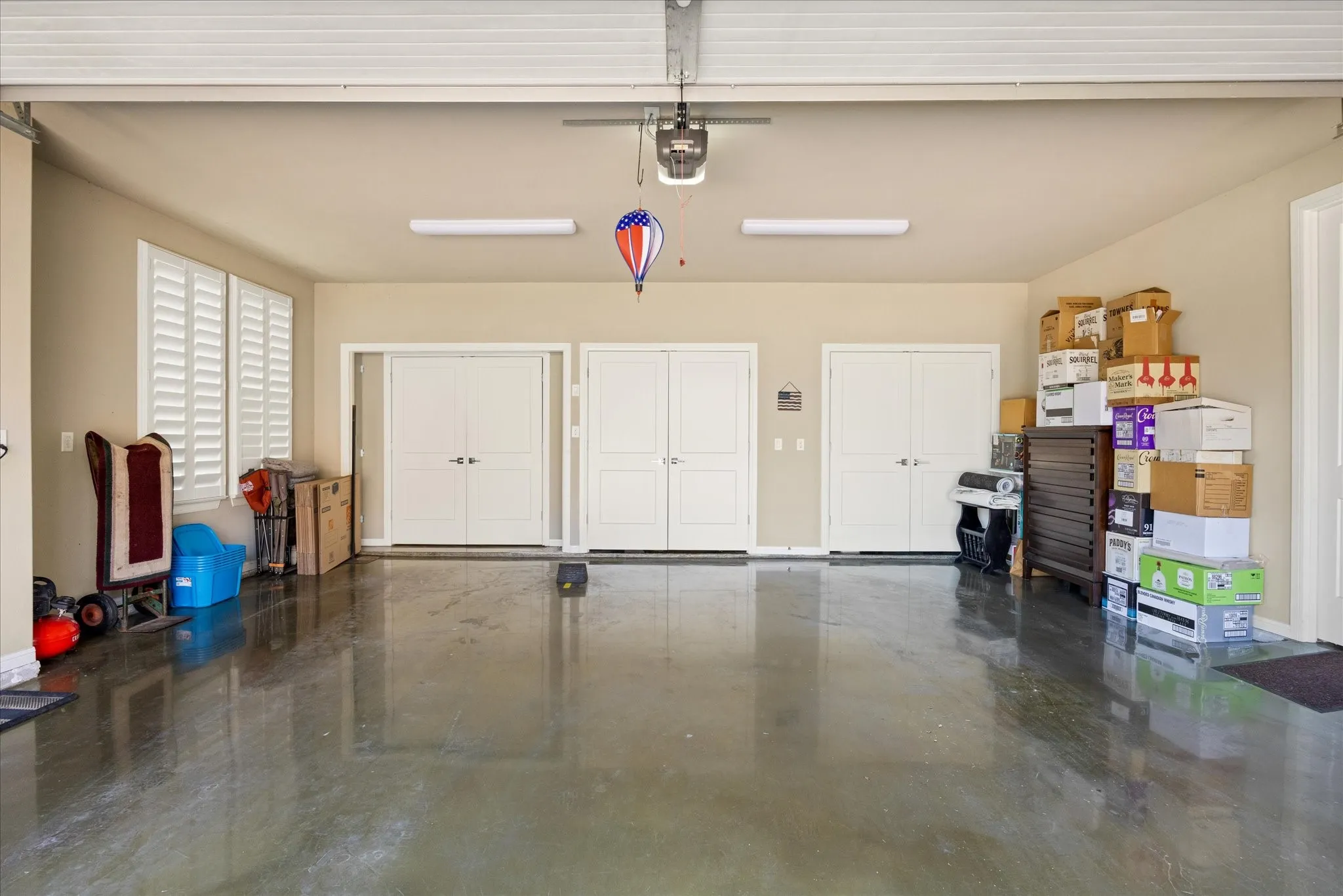Ample garage space with epoxy floor & storage