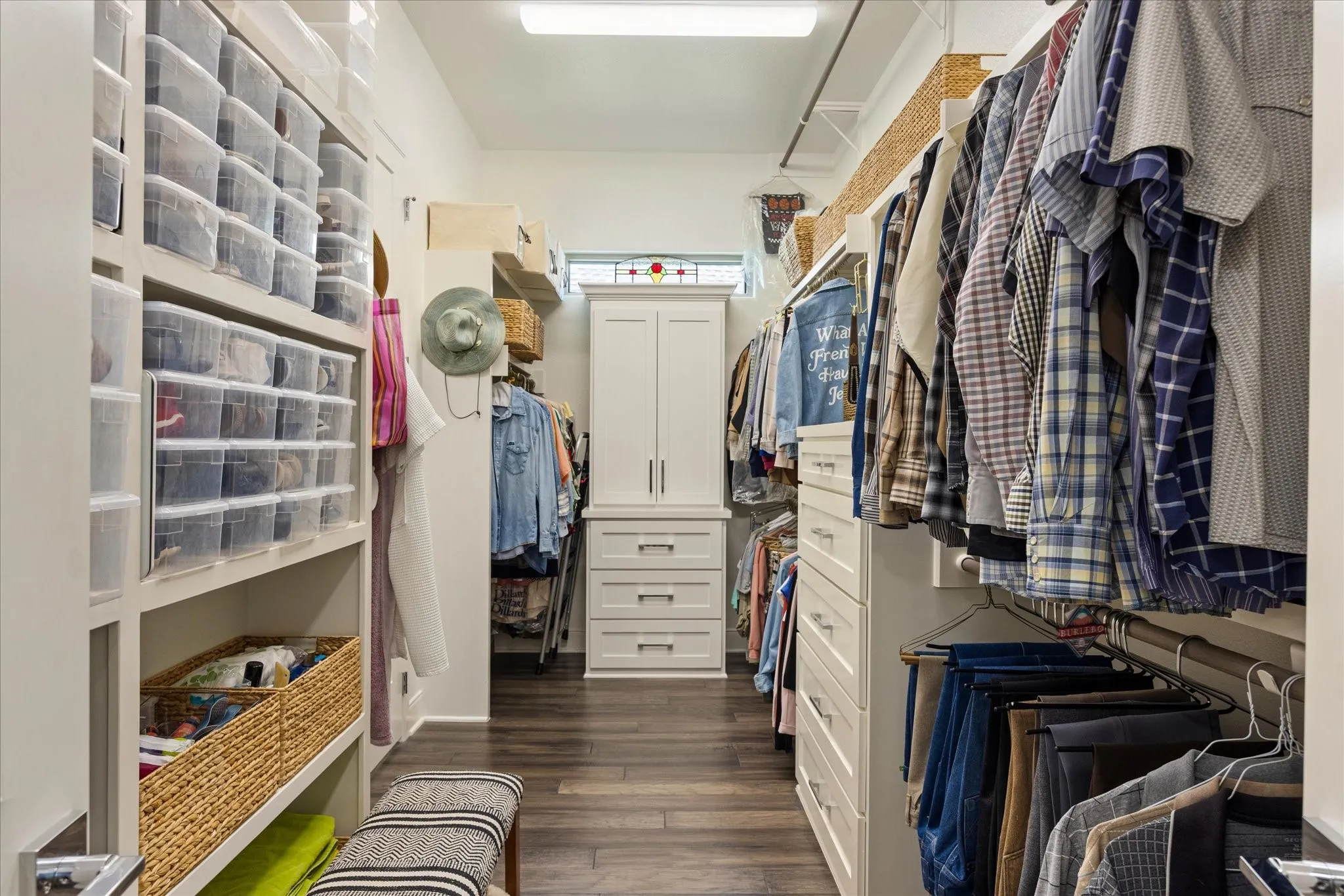 Generously sized primary closet features custom built-in cabinetry, providing exceptional storage and organization.