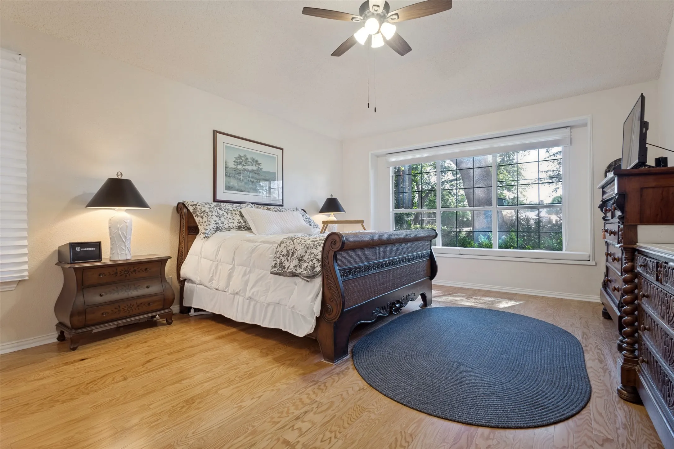 Private and located in the back downstairs, hardwoods, high tiered ceiling detail, with a window seat, zebra blinds- light and bright!
