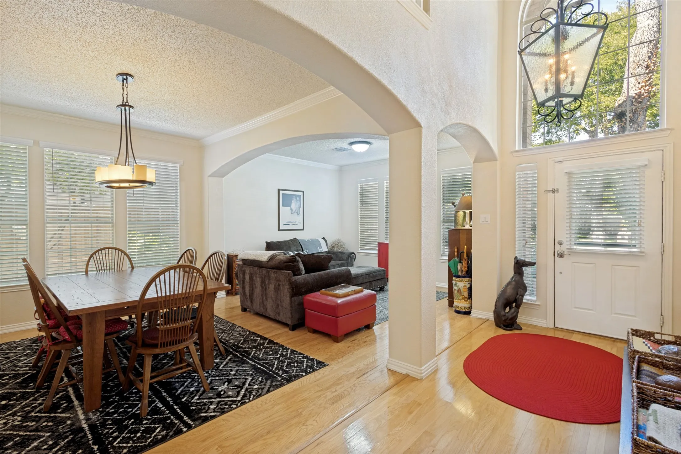 Stunning stacked front formal living and dining!Sleek light hardwoods, fresh interior paint, updated lighting, high ceilings, arched openings, art niches and display areas through-out.