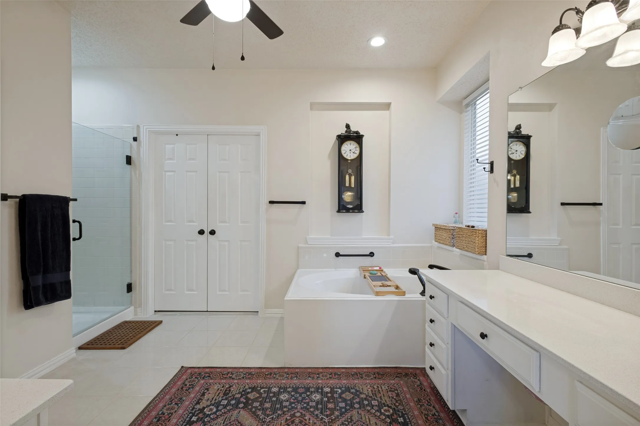 Separate glass framed shower & romantic corner tub. Stylish updated lighting, hardware and high ceilings.See the walk-in closet with great storage & built in chest of drawers.
