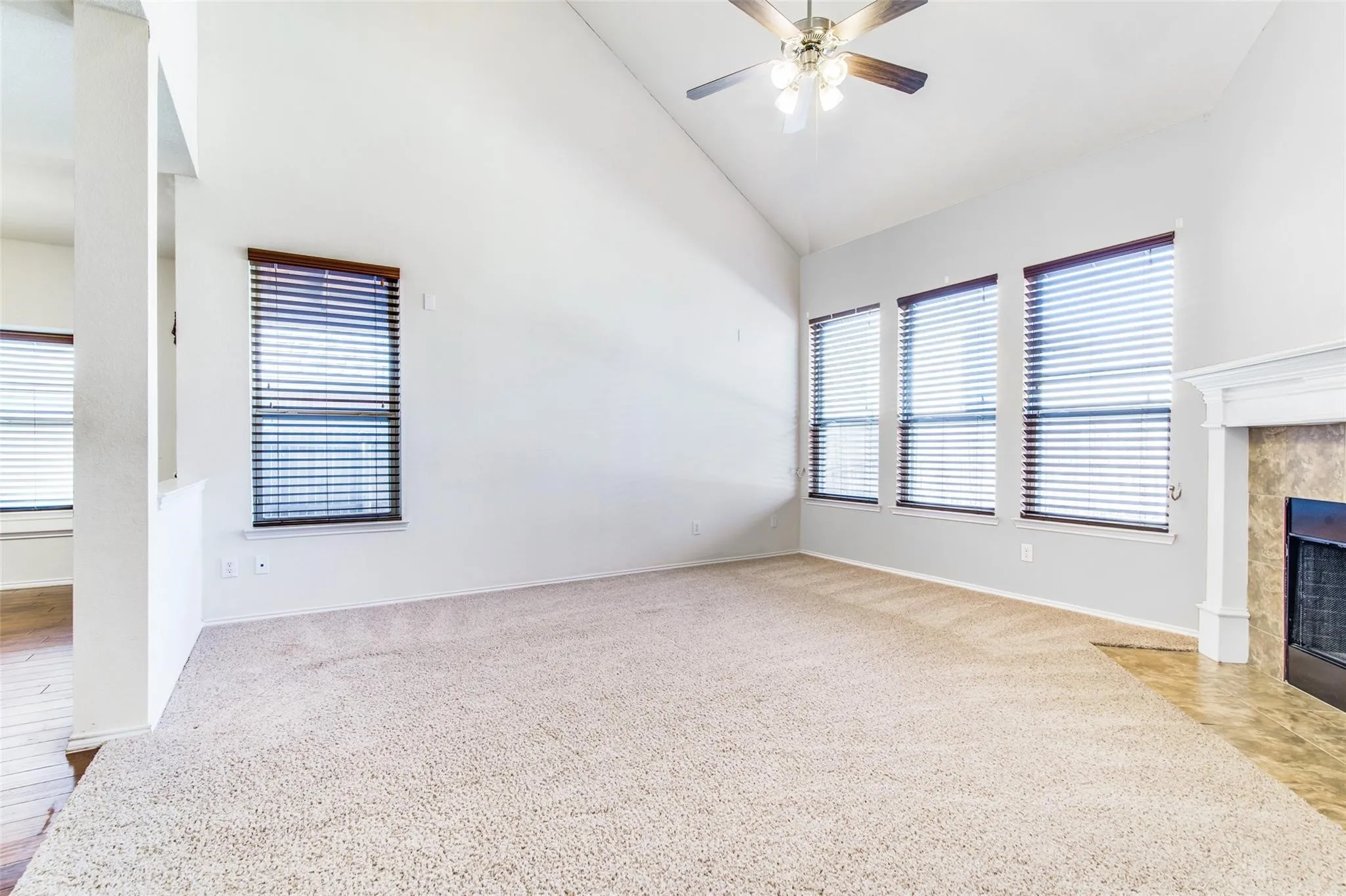 Family room with fireplace and tall ceilings.