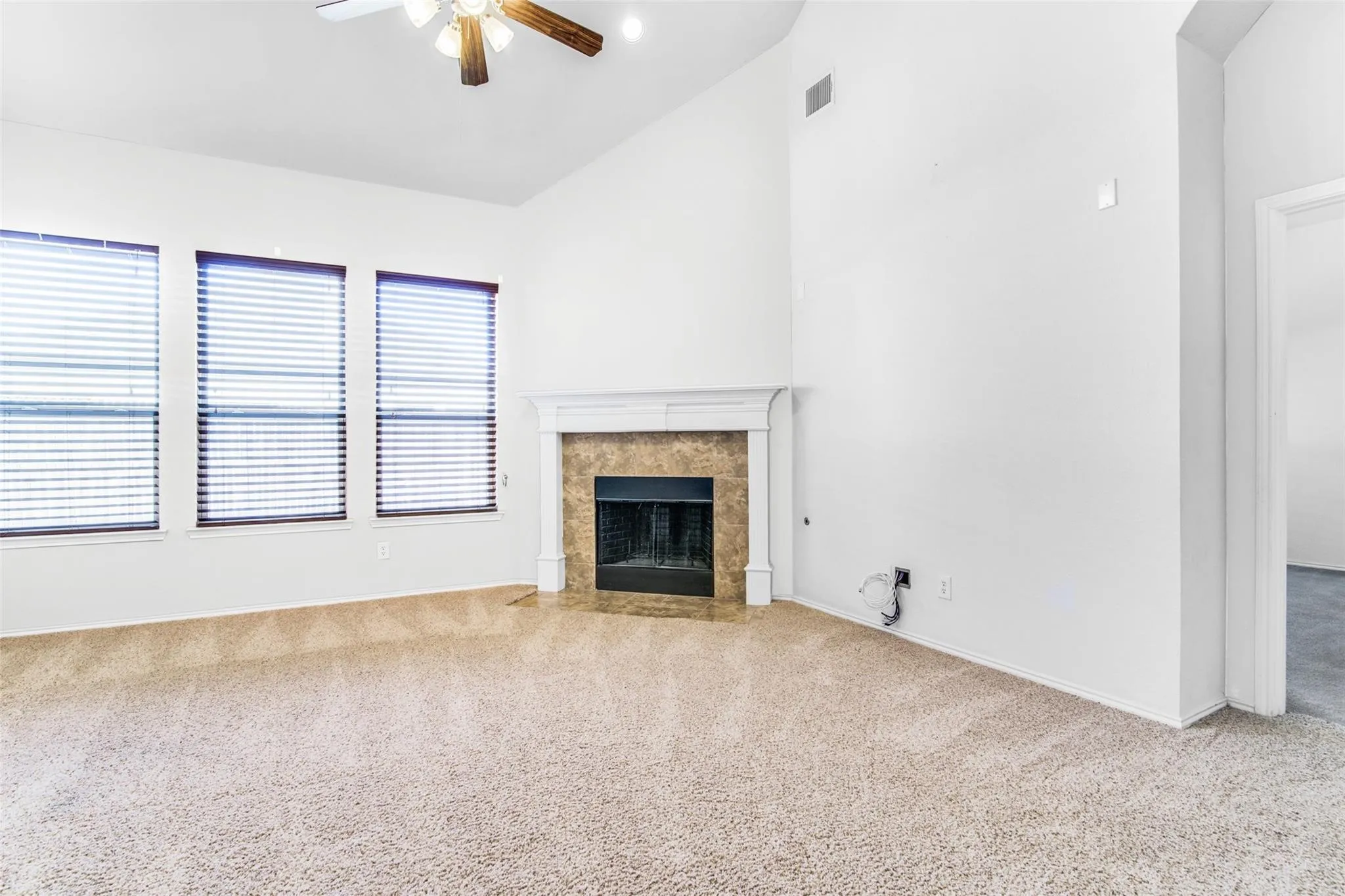 Family room with fireplace and tall ceilings.