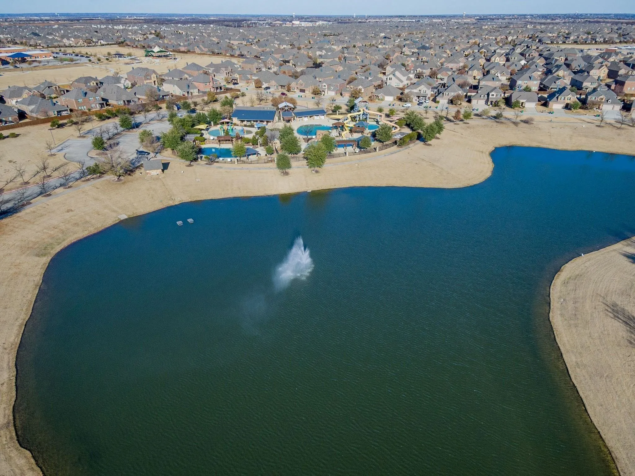 Birds eye view of property with a water view