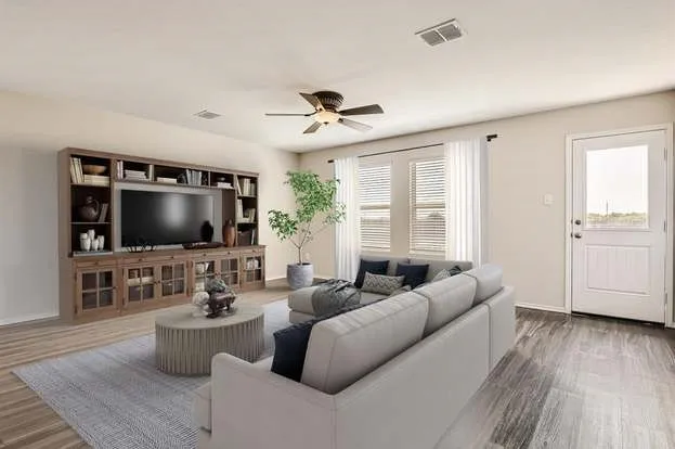 Wood-finish flooring throughout, light-toned walls, and a built-in media center with shelving