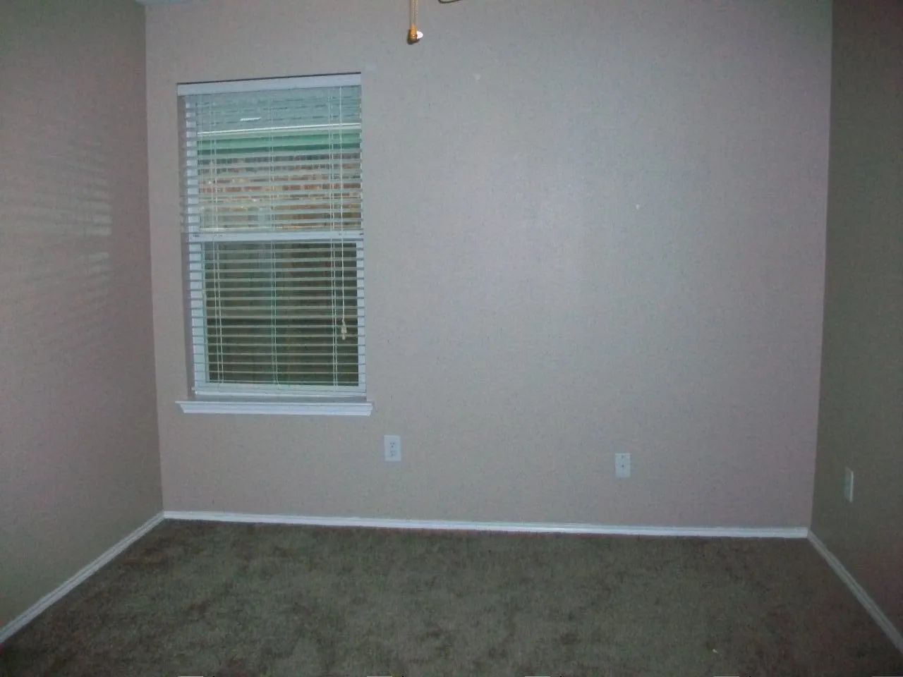 Neutral wall paint with window featuring horizontal blinds and white trim