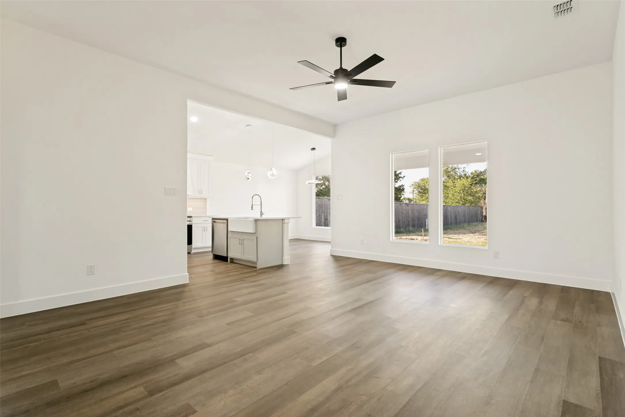 Open-concept living space with wood-finish flooring