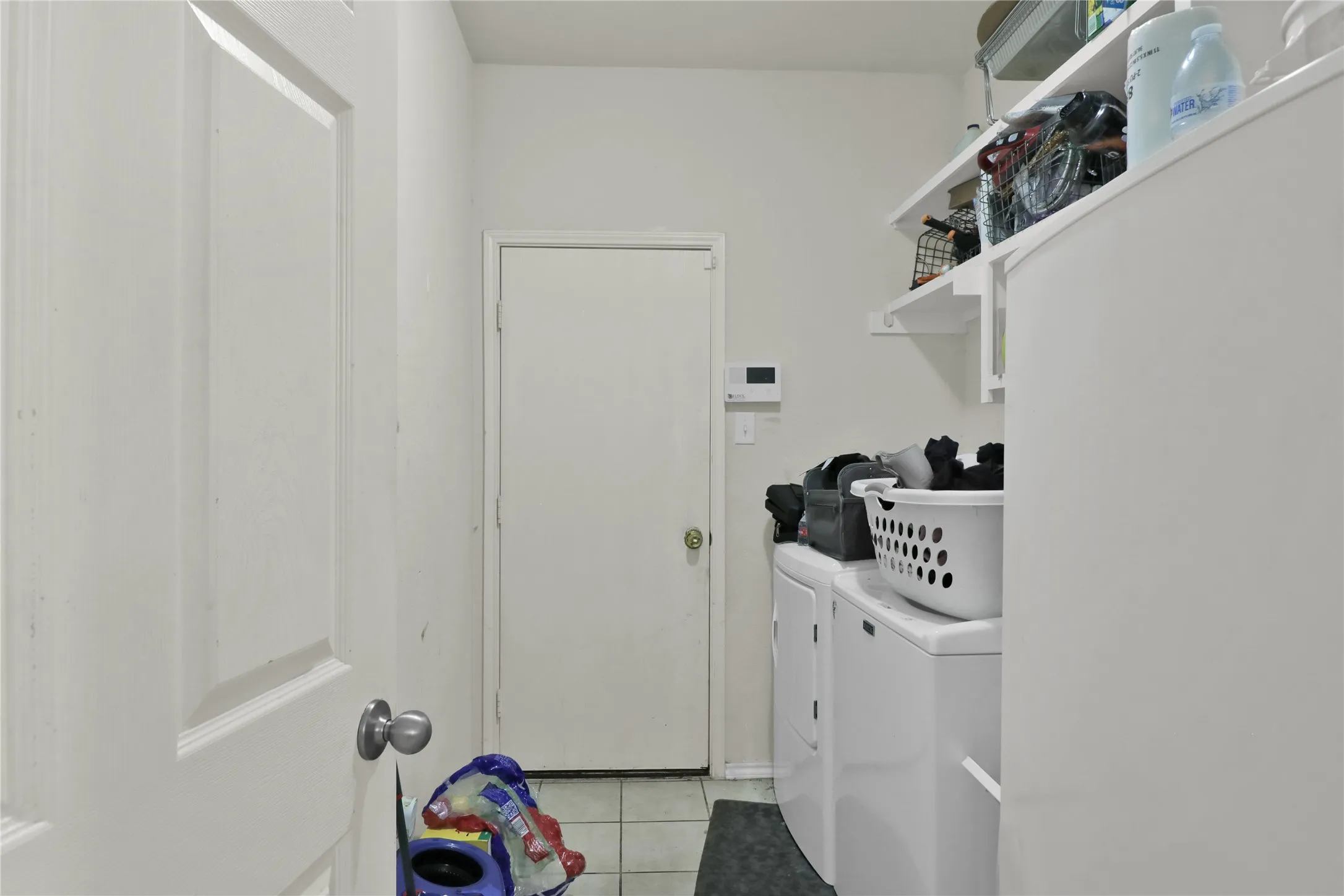 Laundry with drip dry area and shelves.