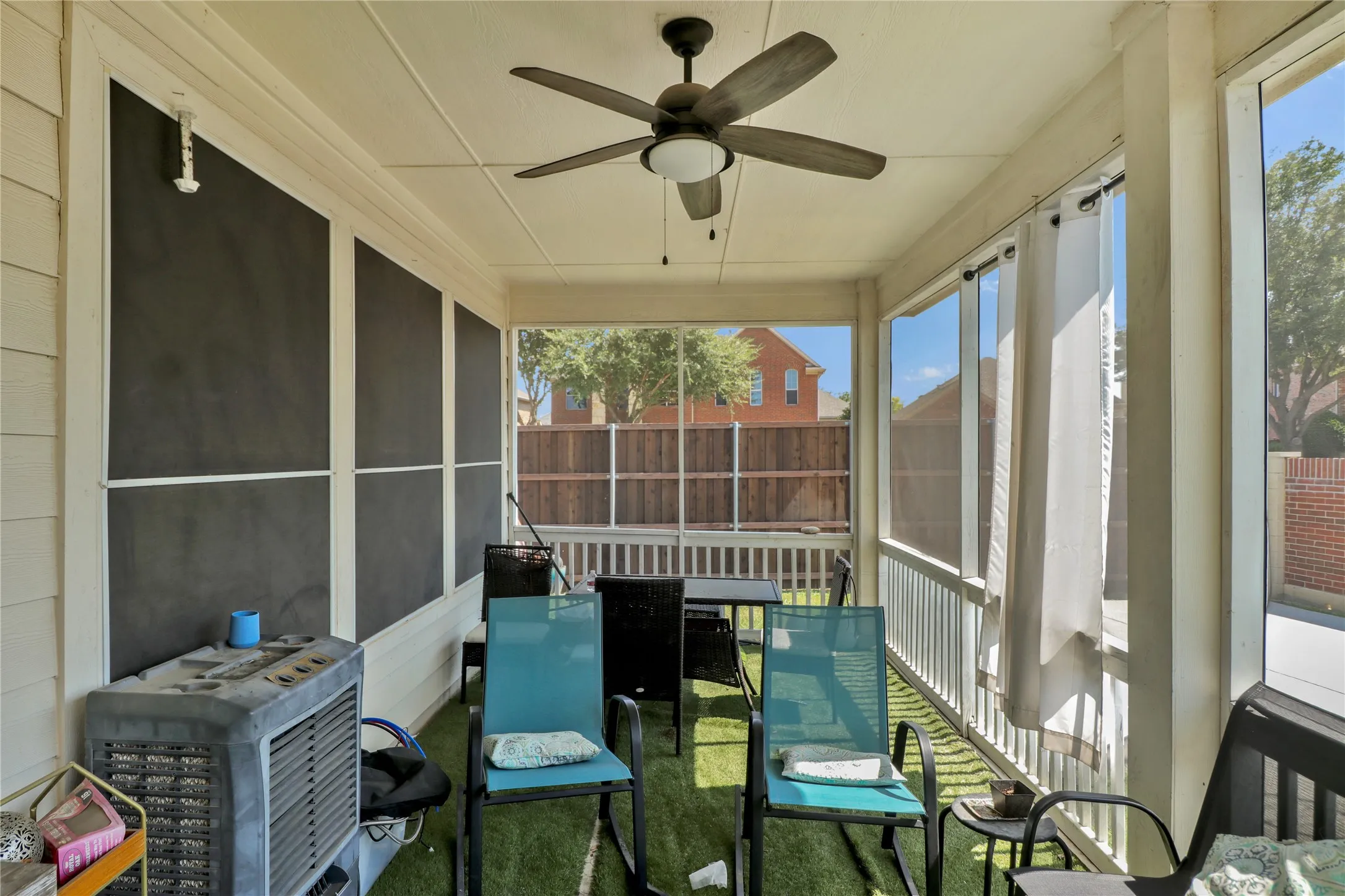 Screened in patio with ceiling fan.