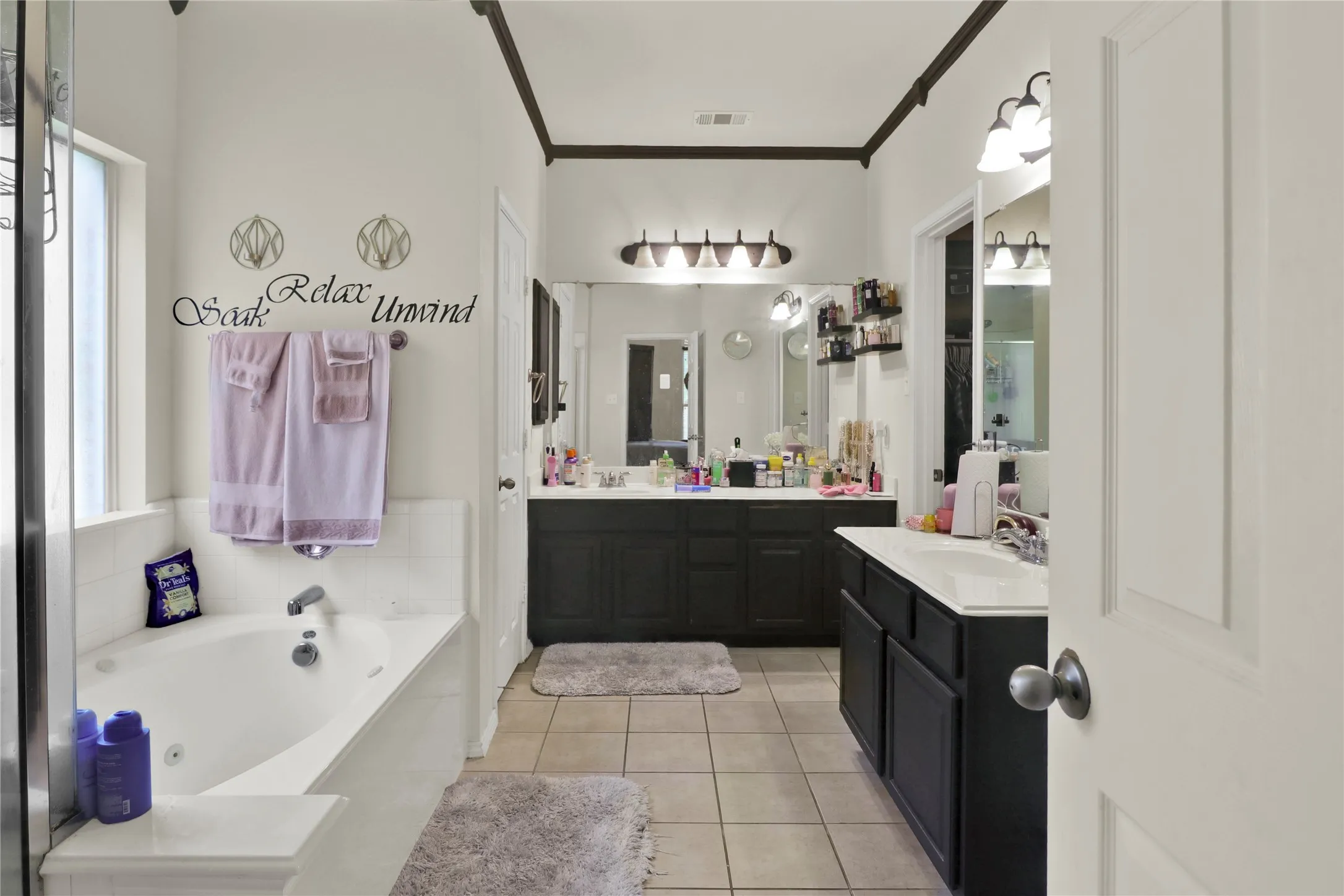 Master bath with jetted tub and dual vanities.