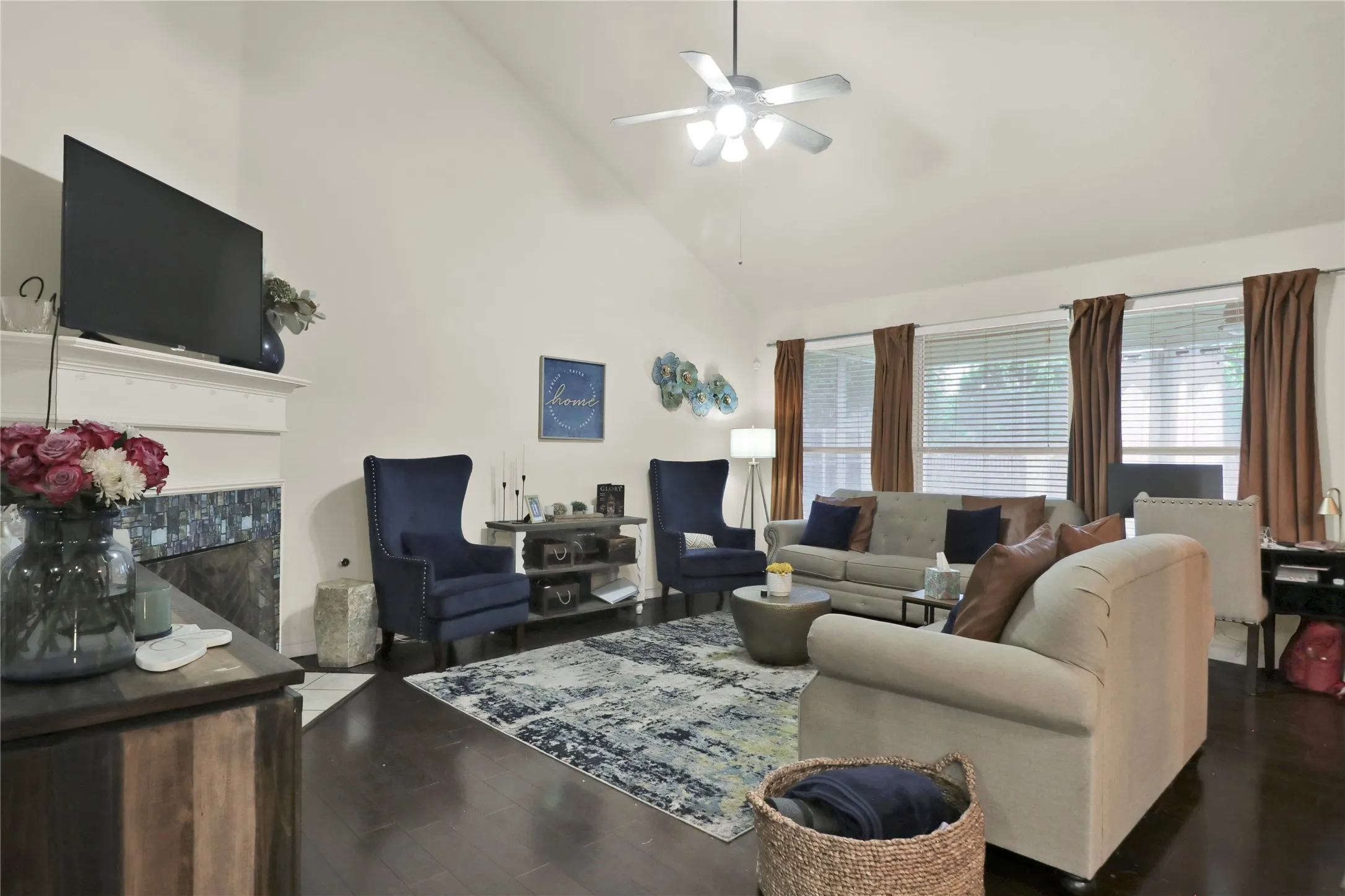 Living room with fireplace and mantle. Windows allow ample natural light.