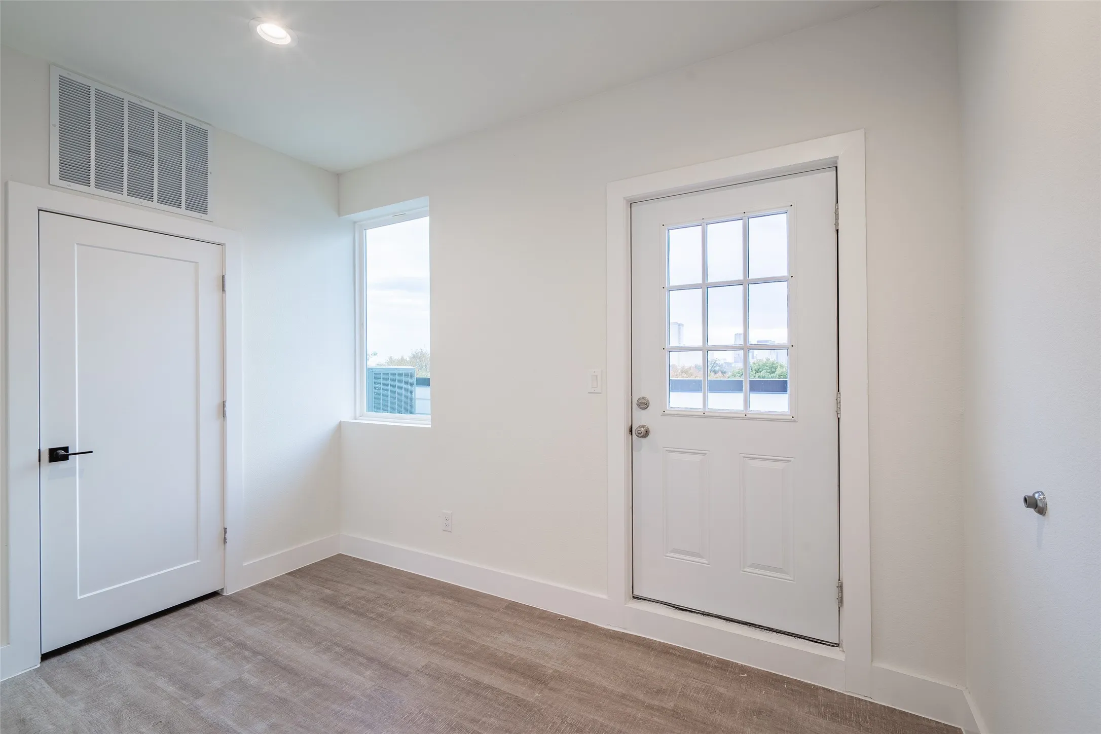 Doorway to outside with light wood-type flooring