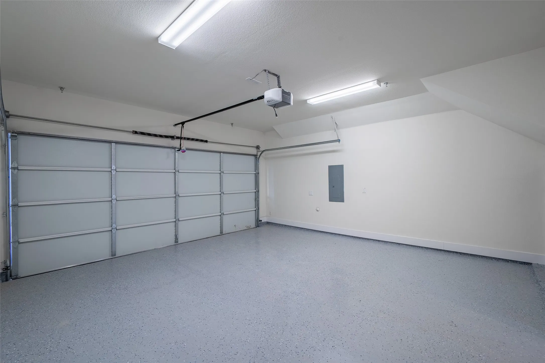 Garage with electric panel and a garage door opener