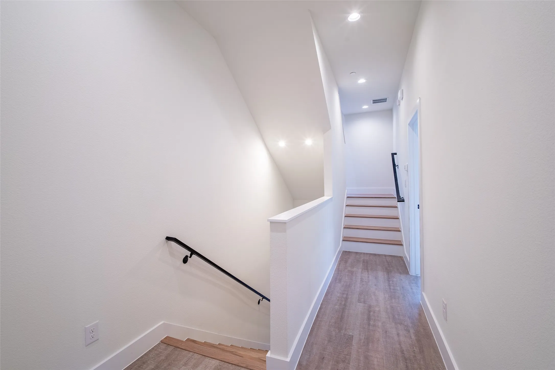 Stairway featuring wood-type flooring