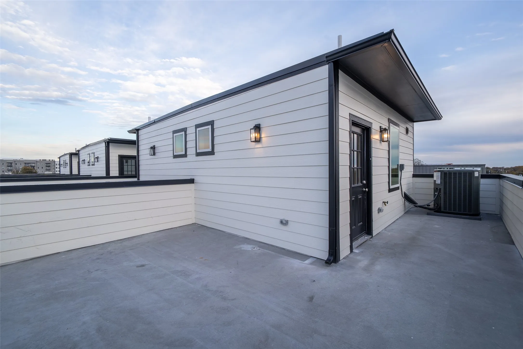 View of side of home featuring cooling unit and a patio
