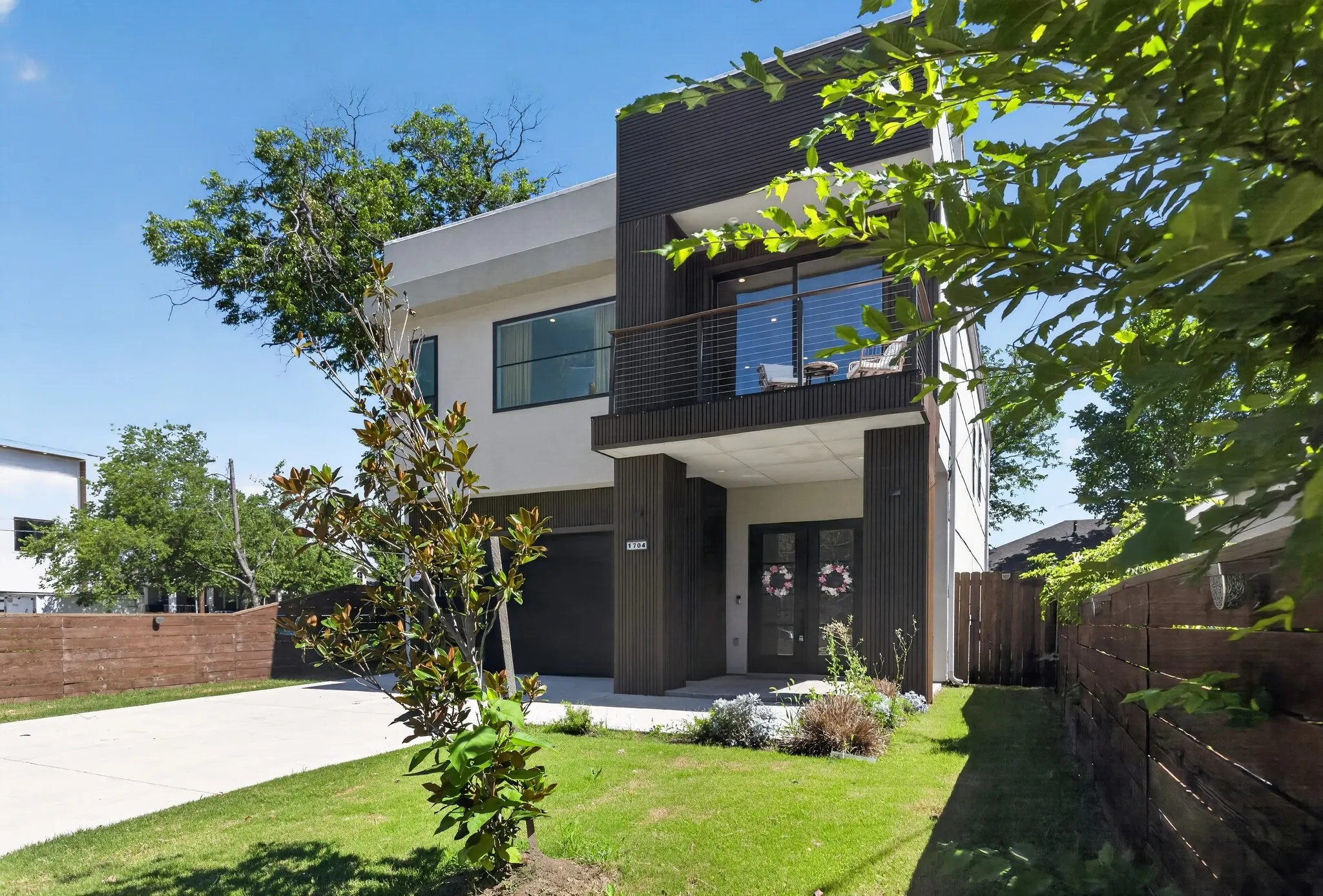 Modern facade with clean lines and a second-story balcony