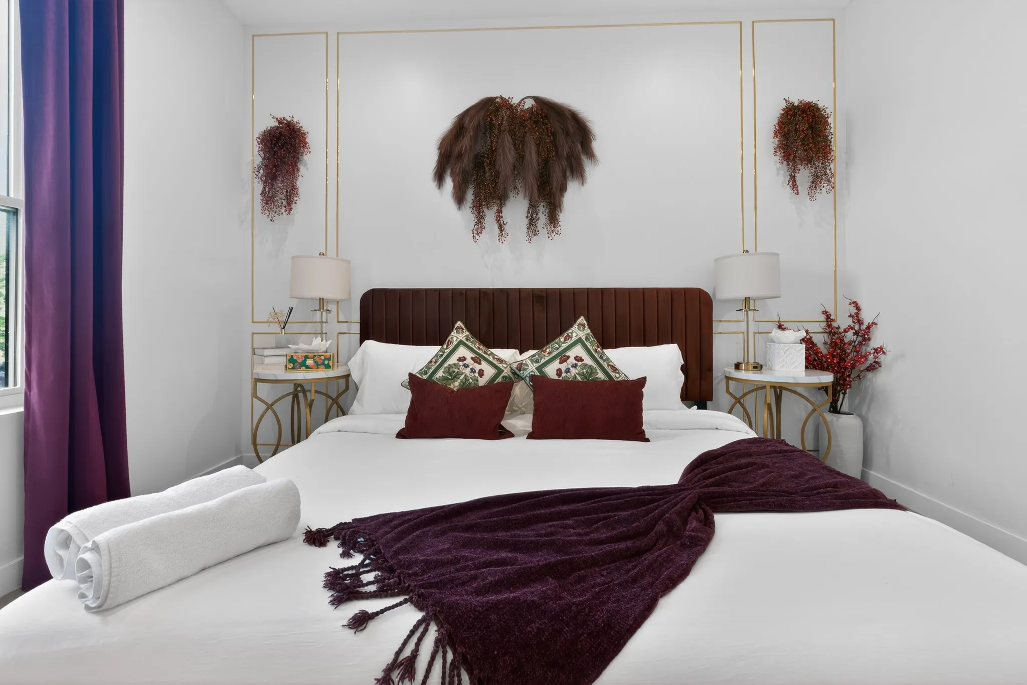 Integrated window with deep purple curtains, a dark wood-finish headboard, and decorative wall molding