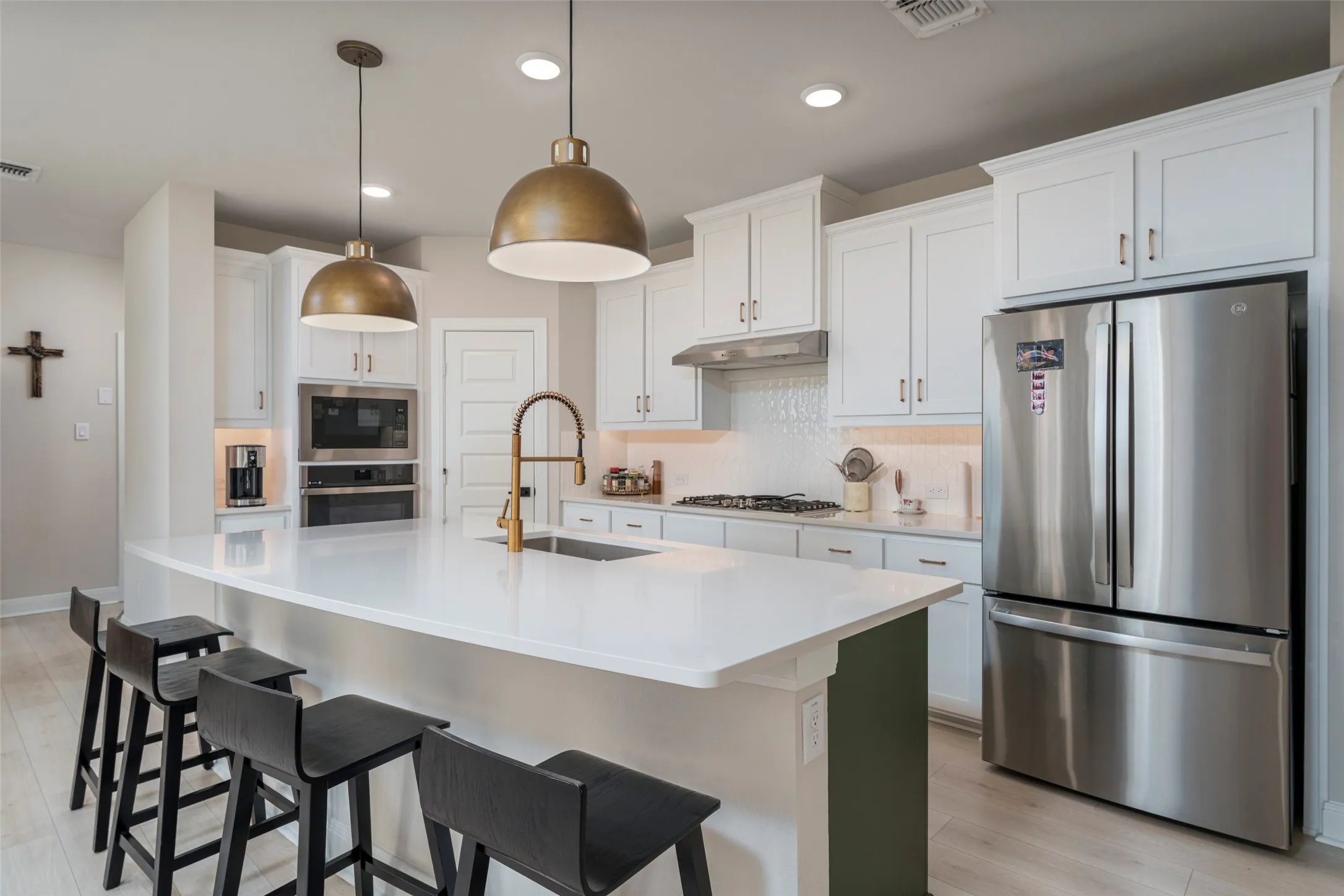 Picture cooking and eating in the fabulous kitchen with gas stove top.  Tons of storage in these beautiful white cabinets.