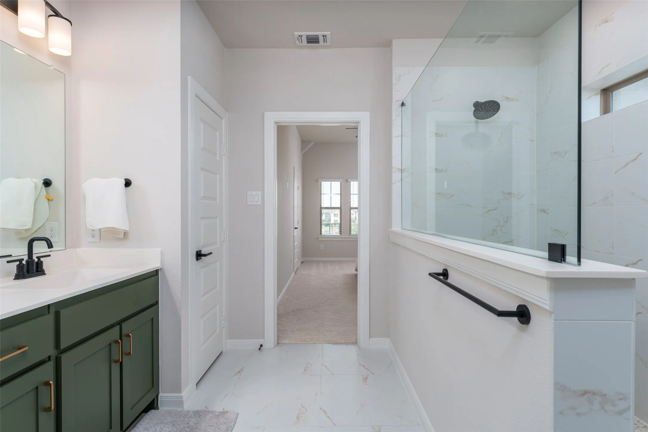 Primary bathroom with a huge walk in shower.
