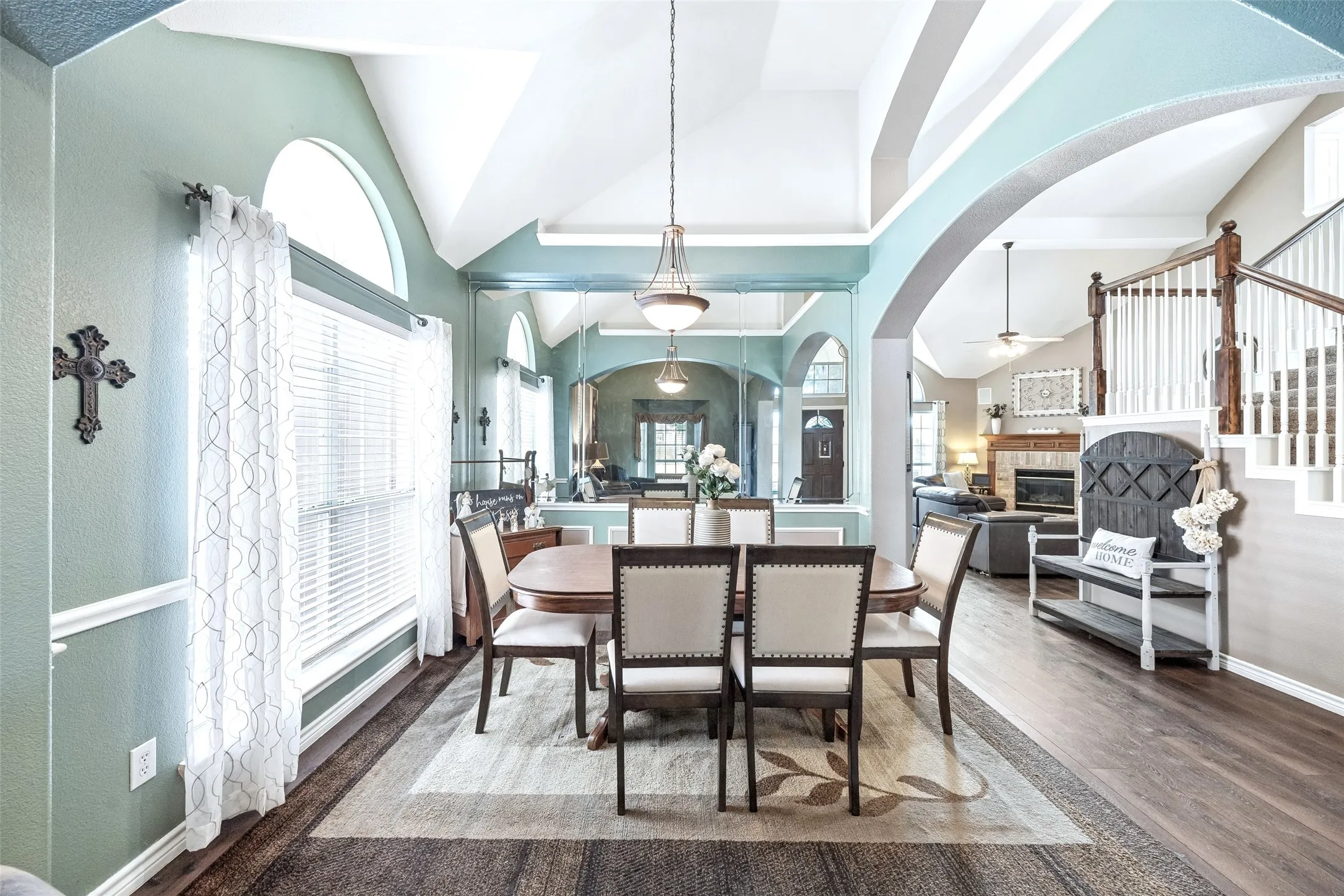 A Clear View Toward the Heart of the Home — From the dining room, the open archway provides a direct sightline toward the family room and staircase, illustrating how the formal spaces connect naturally with the more casual areas of the home.
