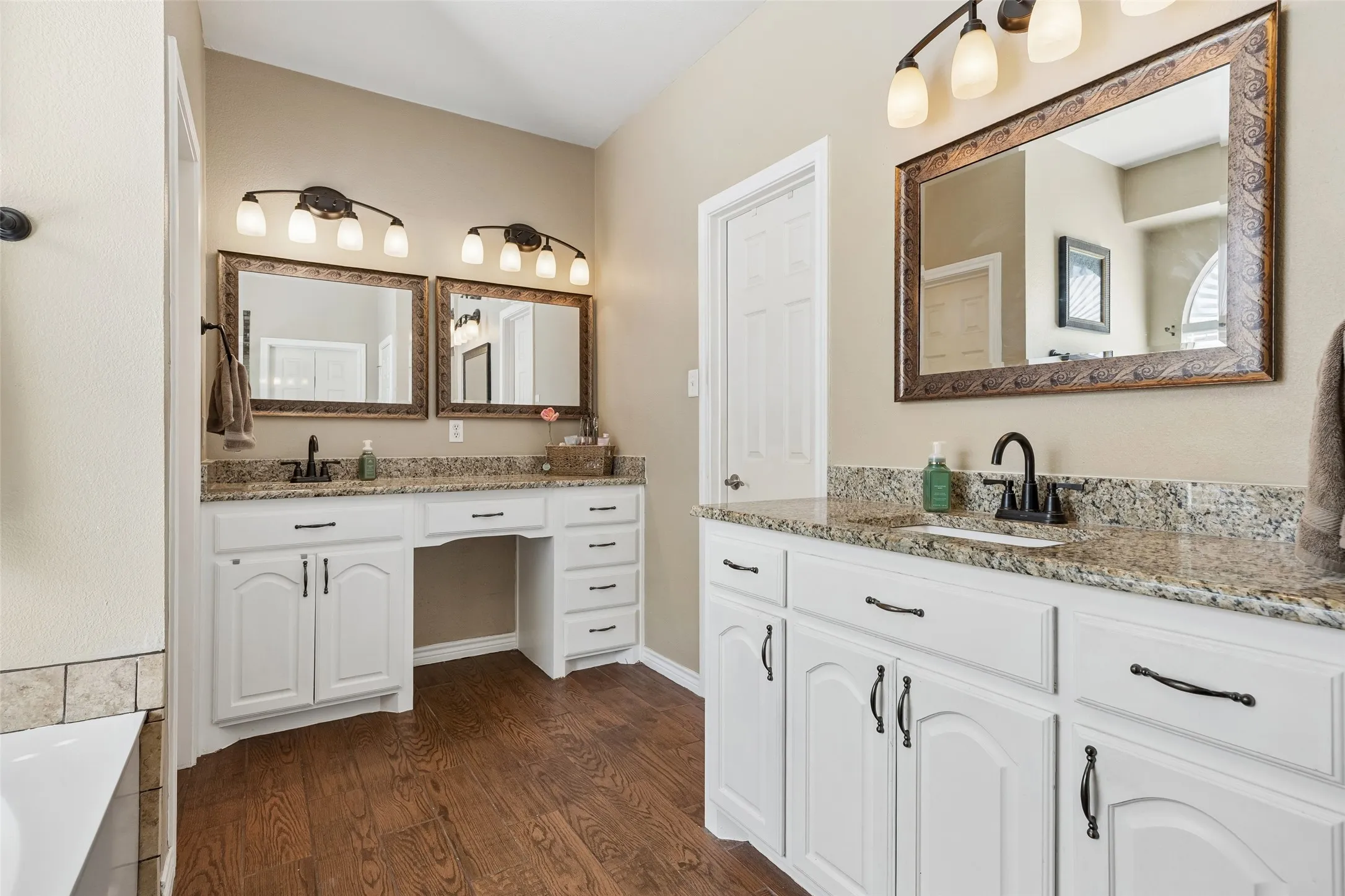 More Counter Space Where It Matters — Separate granite-topped vanity areas provide additional personal space in the primary bath, with cabinetry and drawers offering plenty of storage for toiletries, linens, and everyday essentials.