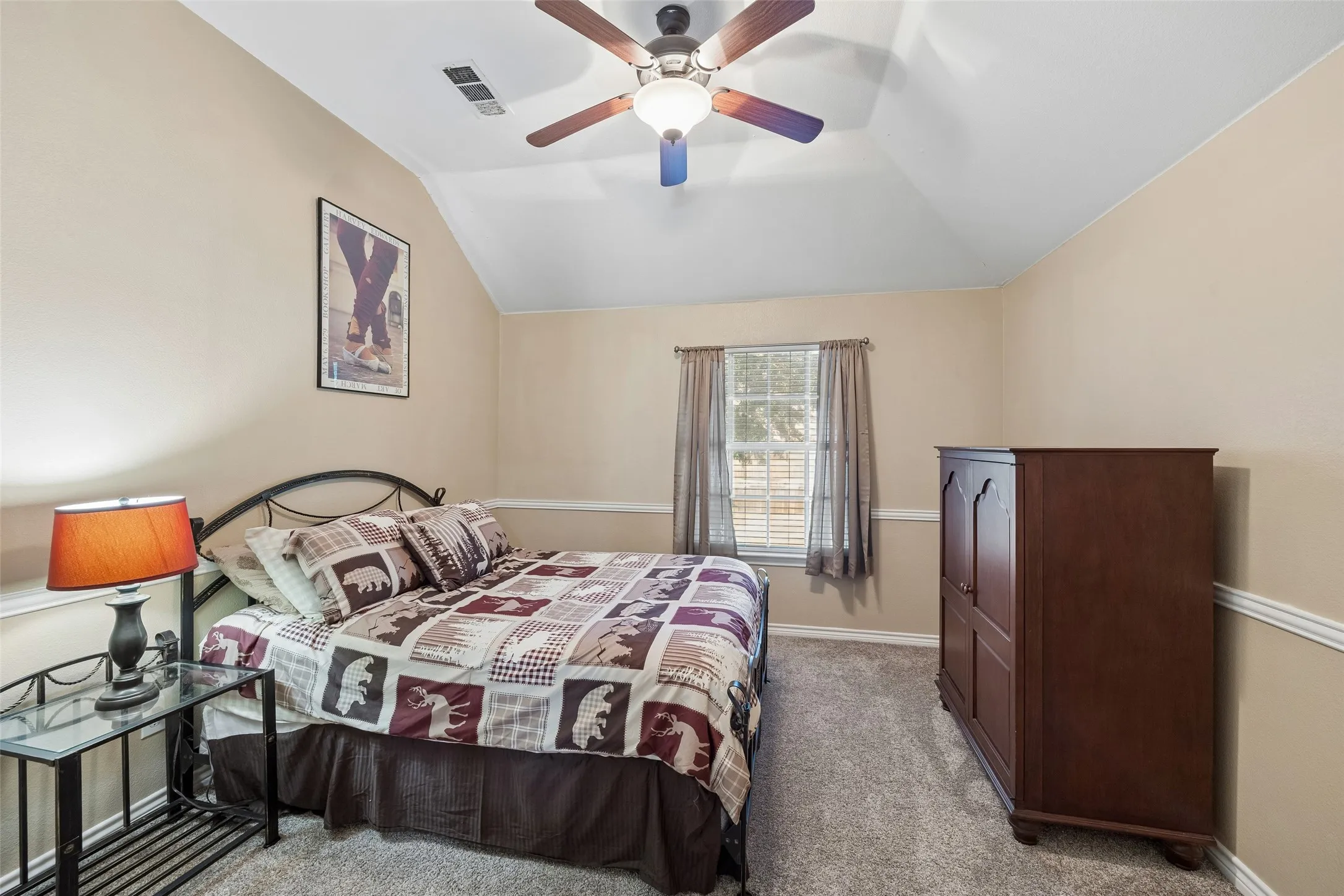 Flexible Secondary Bedroom — This upstairs bedroom offers enough space for both sleeping and study areas, with a vaulted ceiling, ceiling fan, window, and closet providing the essentials for a functional private room.