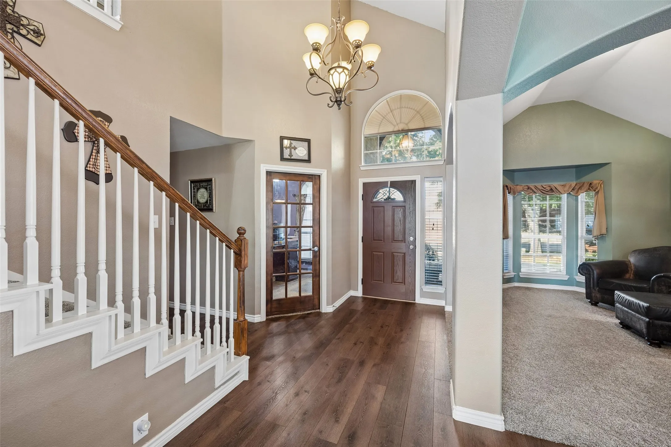 Two-Story Foyer with Rooms on Both Sides — The entry is more than a pass-through. A soaring ceiling and transom window bring height and light to the foyer, while the home office and front living area are positioned just steps from the front door.
