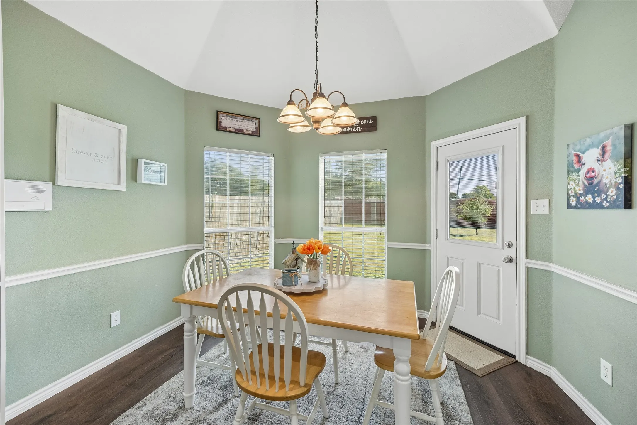 Breakfast Area with Backyard Access — Two large windows bring natural light into the casual dining space, while the exterior door provides direct access to the backyard. Its location immediately beside the kitchen makes indoor-outdoor meals and everyday dining especially convenient.