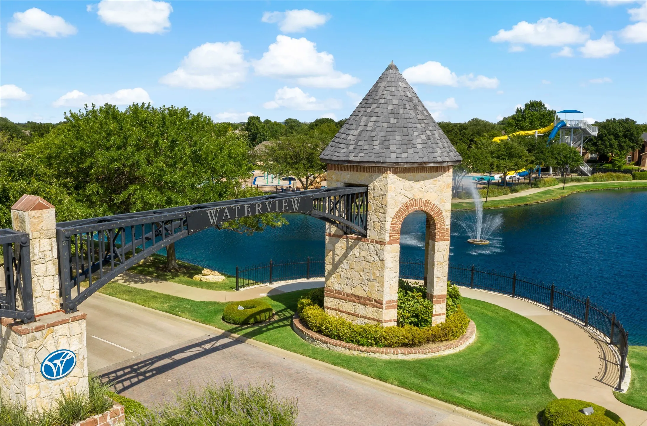 A Distinctive Waterview Welcome - The landscaped neighborhood entrance, stone tower, fountains, and water views create a recognizable sense of arrival while introducing the community’s emphasis on outdoor spaces and recreation.