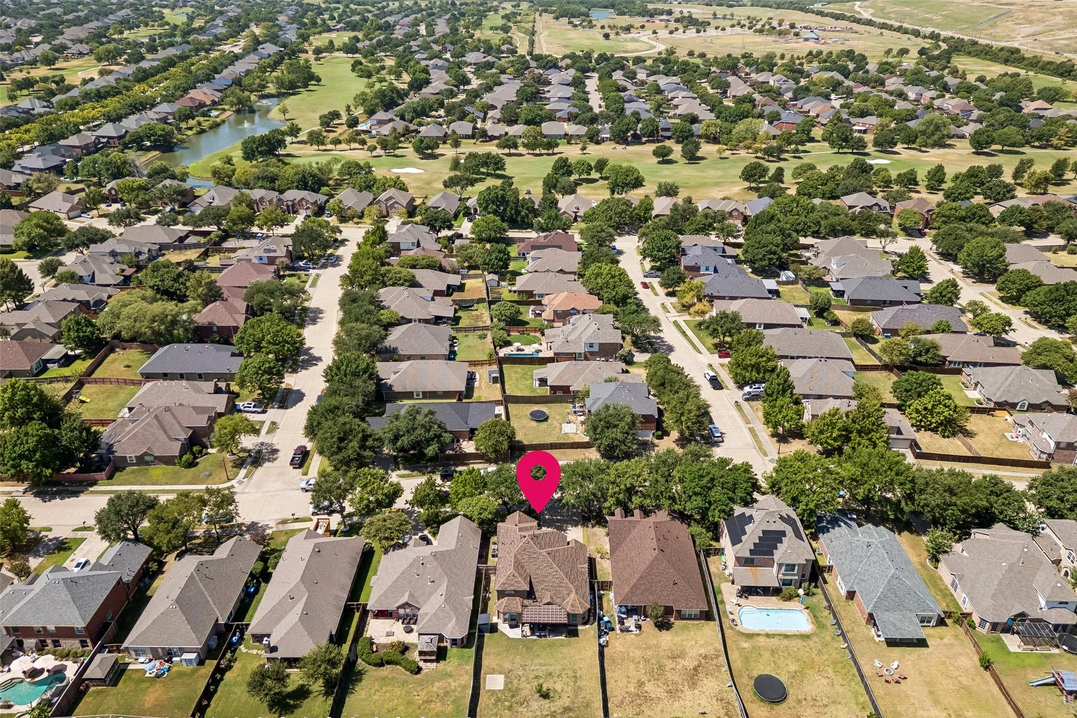 Waterview Neighborhood Setting — The aerial perspective places the home within the surrounding Waterview neighborhood, with the nearby golf course, green space, and water features visible beyond the residential streets.