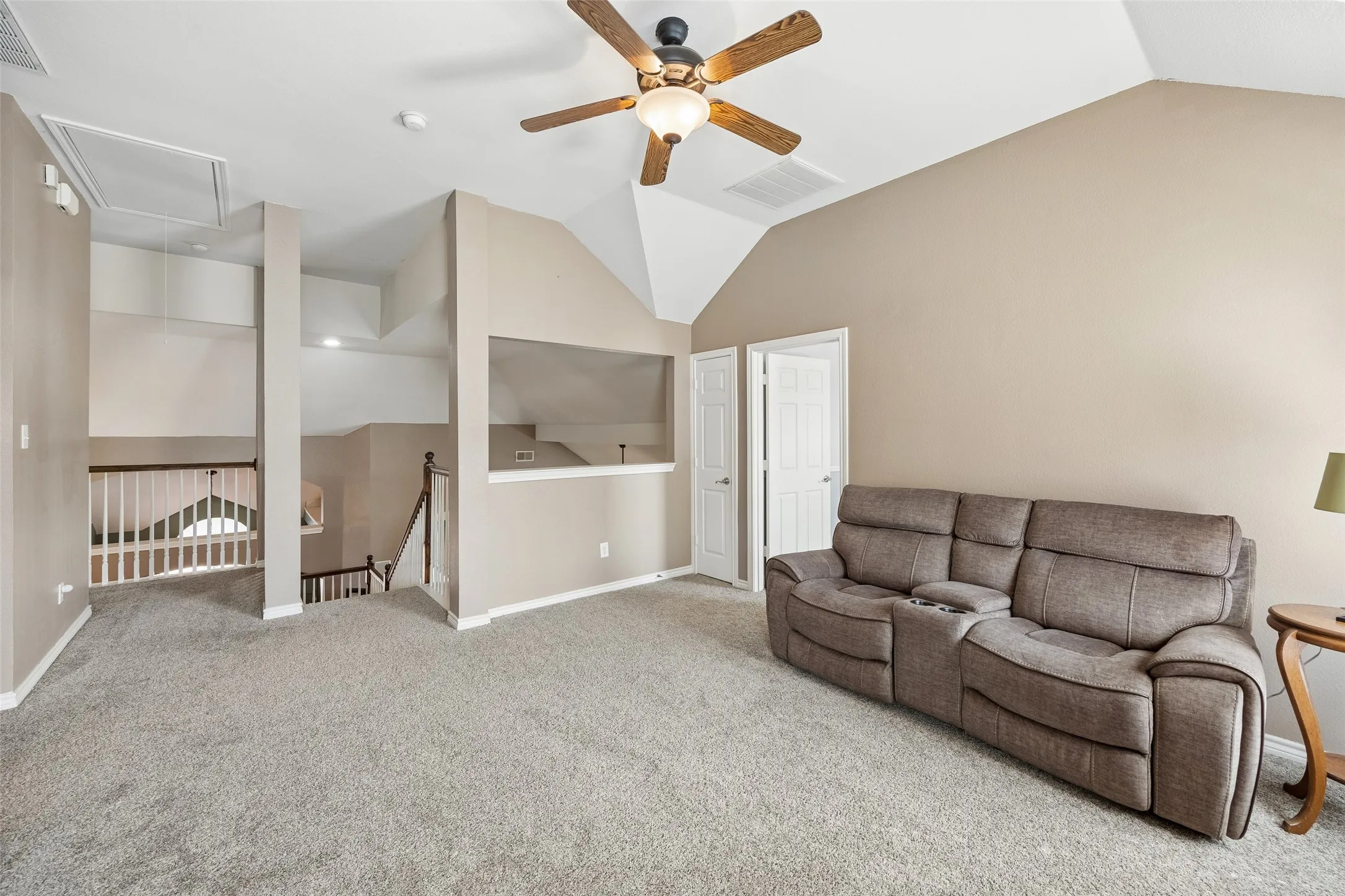 Open Game Room Overlooks the Main Level — The upstairs game room connects directly to the open landing and overlooks the two-story spaces below, reinforcing the home's open architectural design while providing a substantial separate living area upstairs.