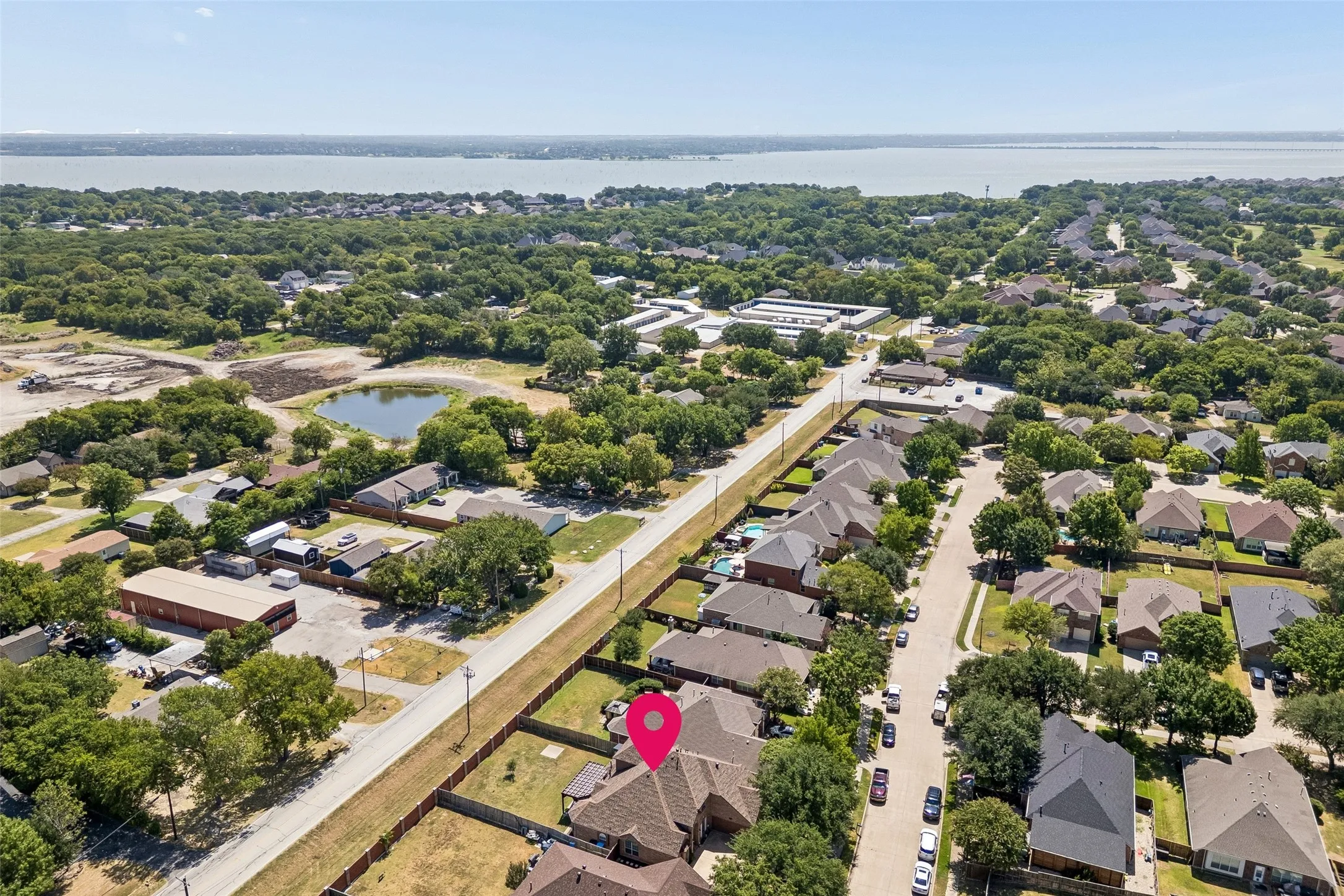 Lake Ray Hubbard Nearby — This wider aerial view shows the home's location within Rowlett and its proximity to Lake Ray Hubbard, adding useful context to the property's setting within the community.