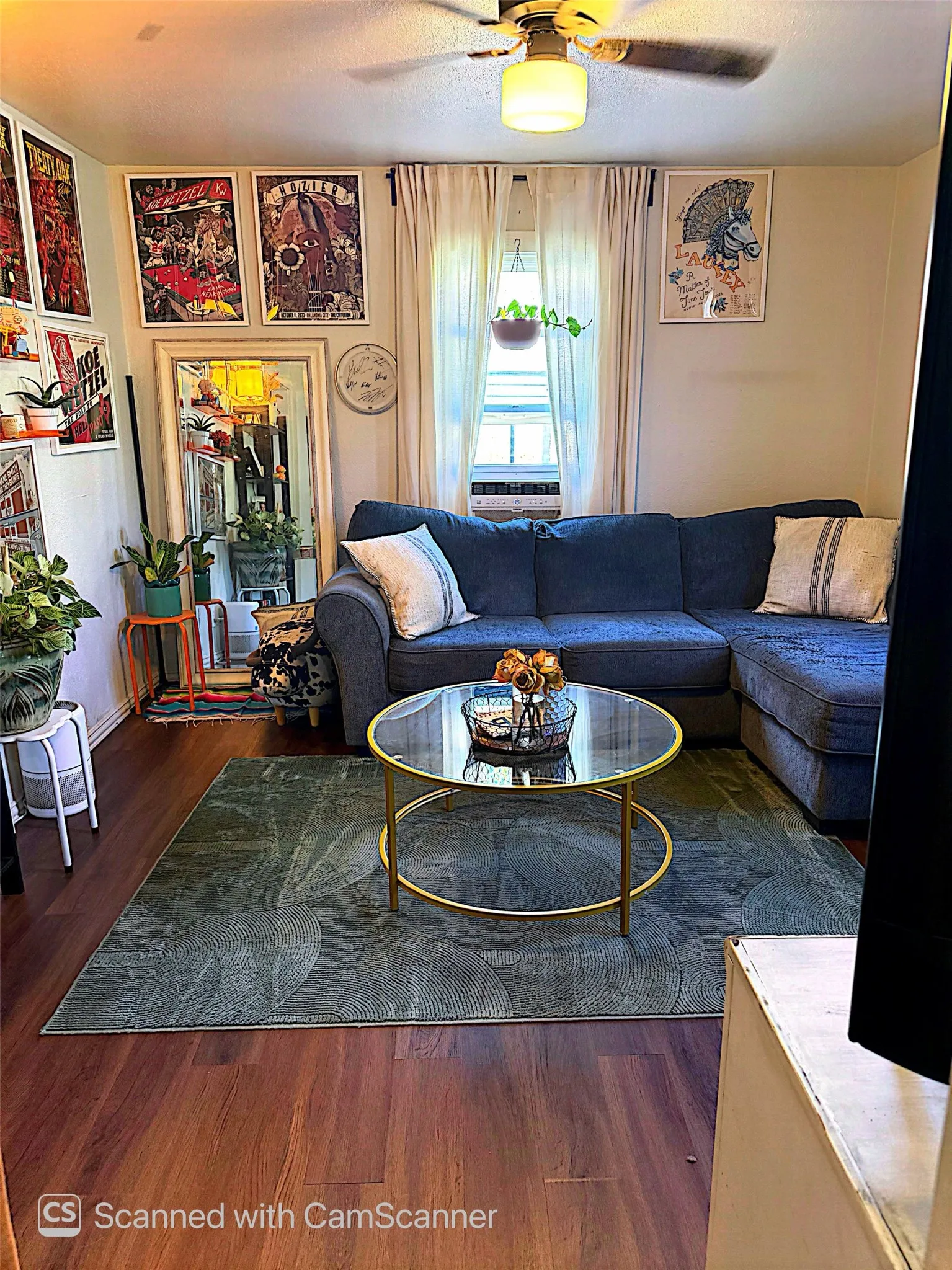 Wood-finish flooring with a ceiling fan light fixture