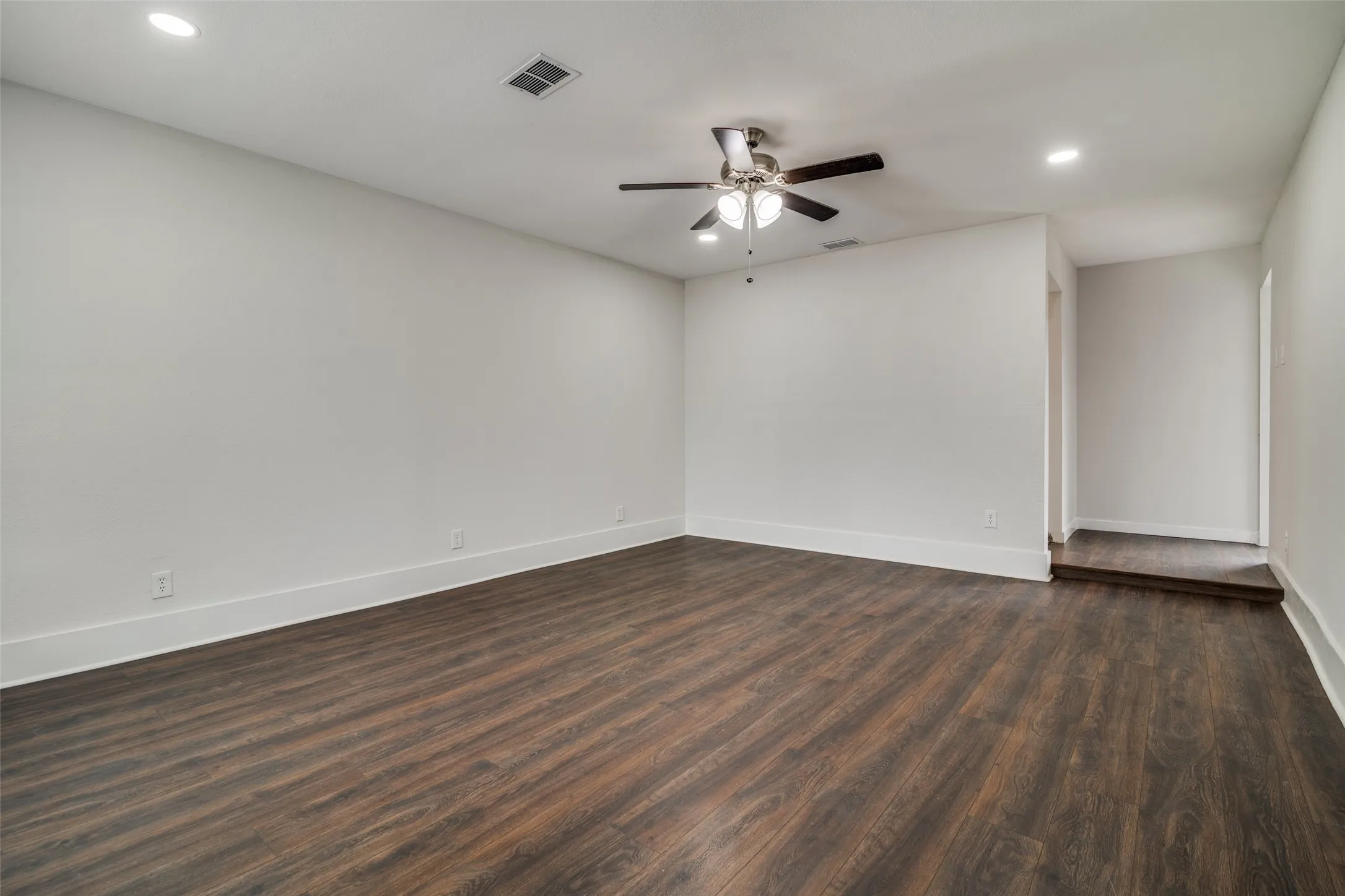 Spare room featuring recessed lighting, dark wood-style flooring, and a ceiling fan
