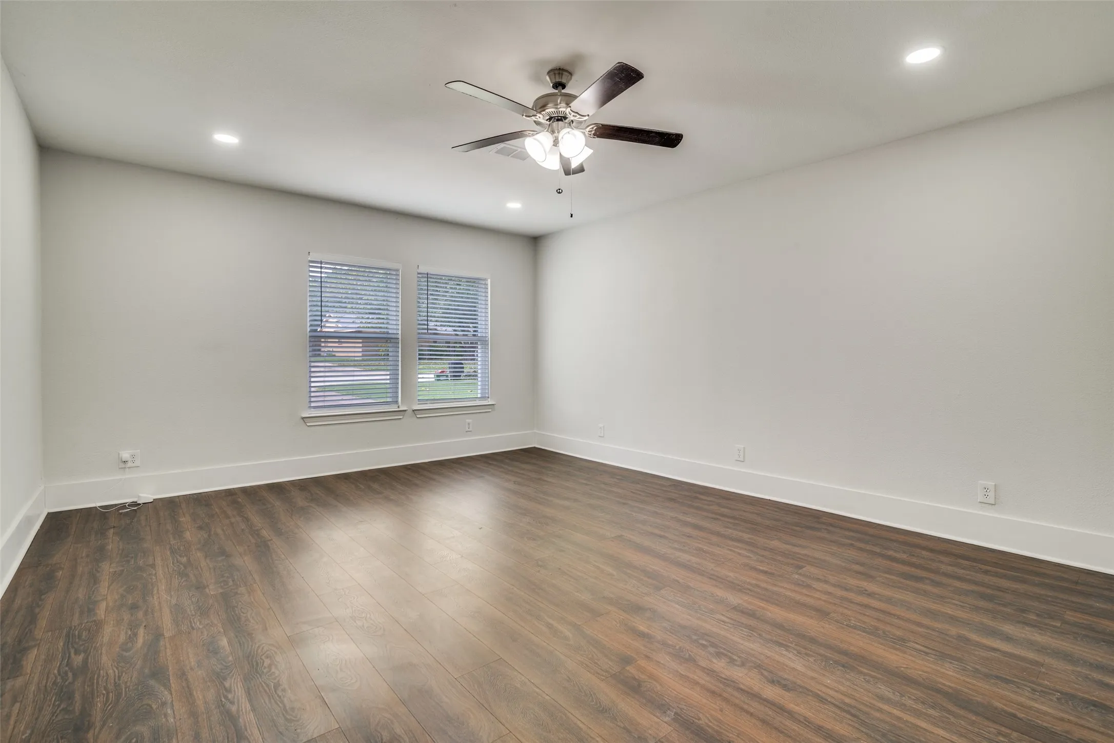 Spare room featuring dark wood-style flooring, recessed lighting, and ceiling fan