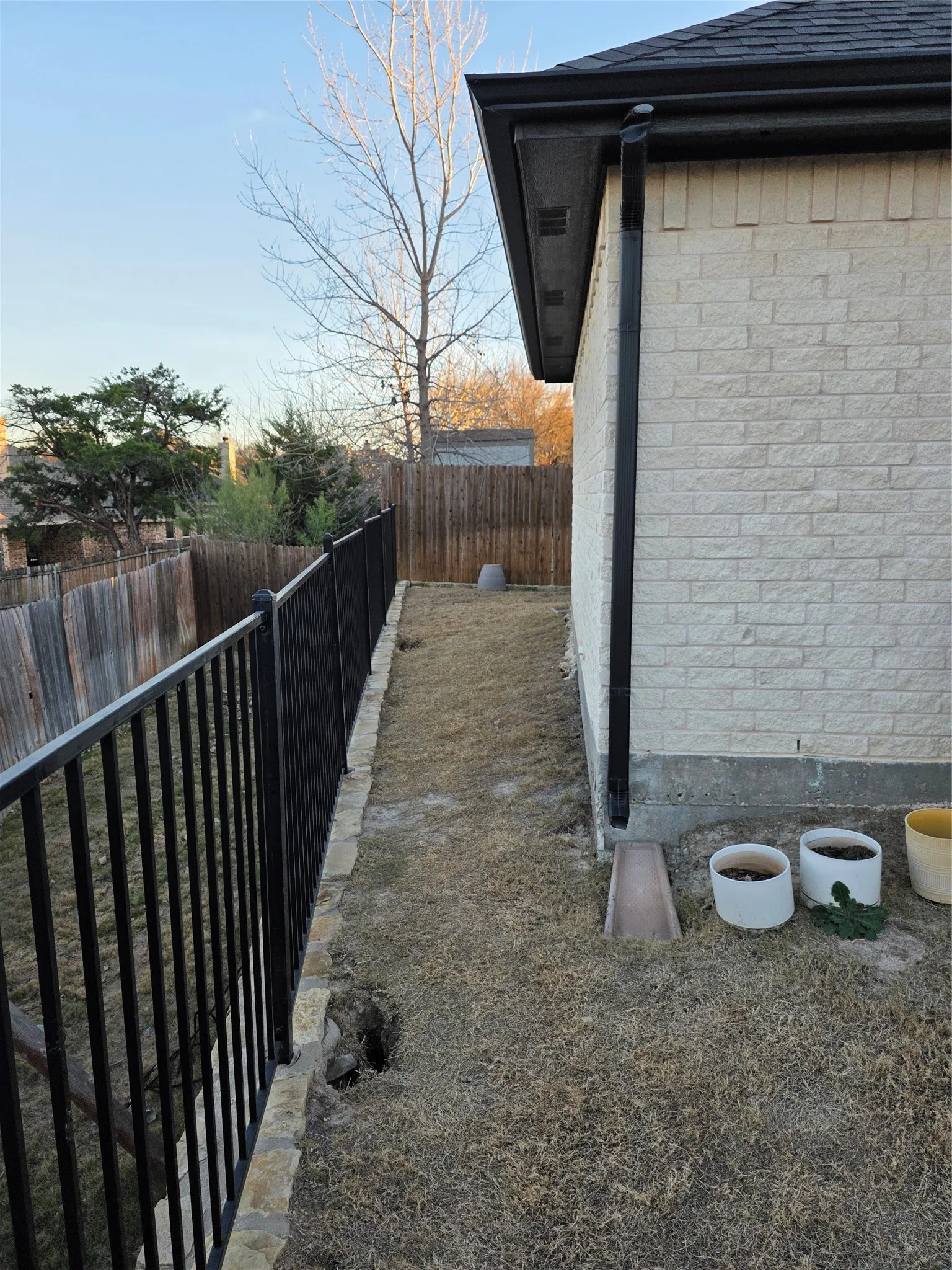 View of side of home with a fenced backyard